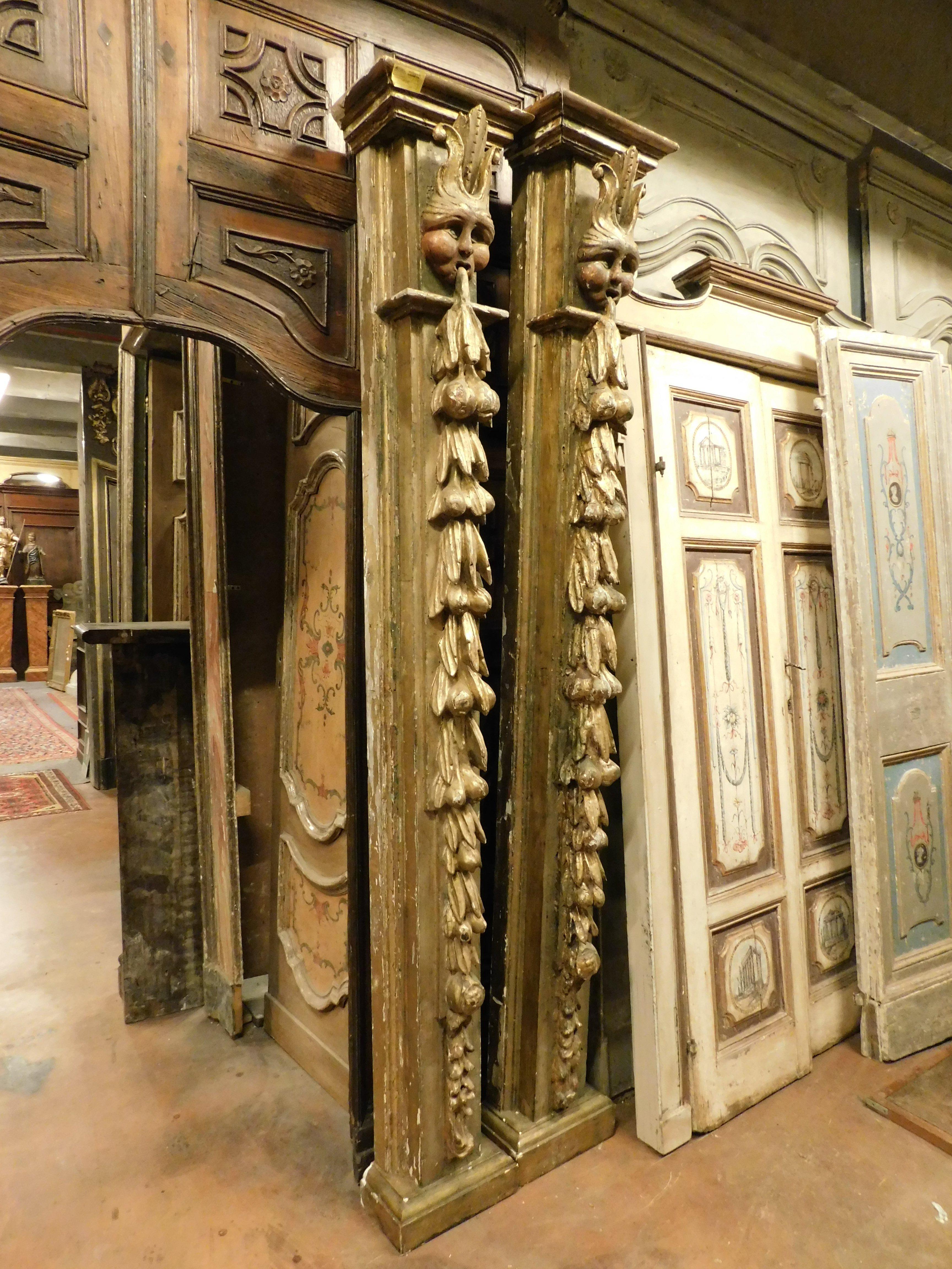 Hand-Carved Pair of columns in gilded, lacquered and carved wood with masks, Spain For Sale