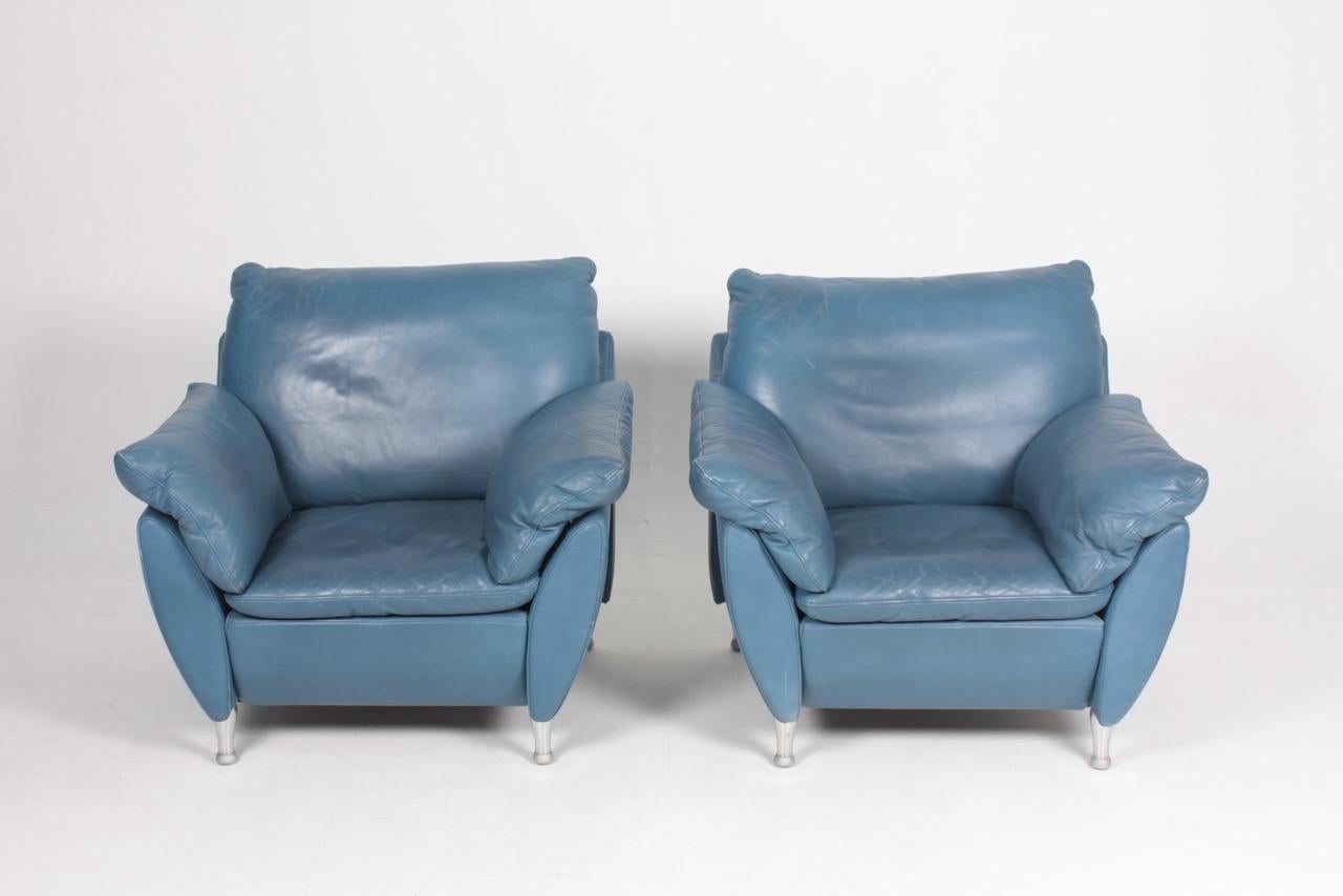 Pair of very comfortable lounge chairs in patinated leather by Rolf Benz. Great original condition.