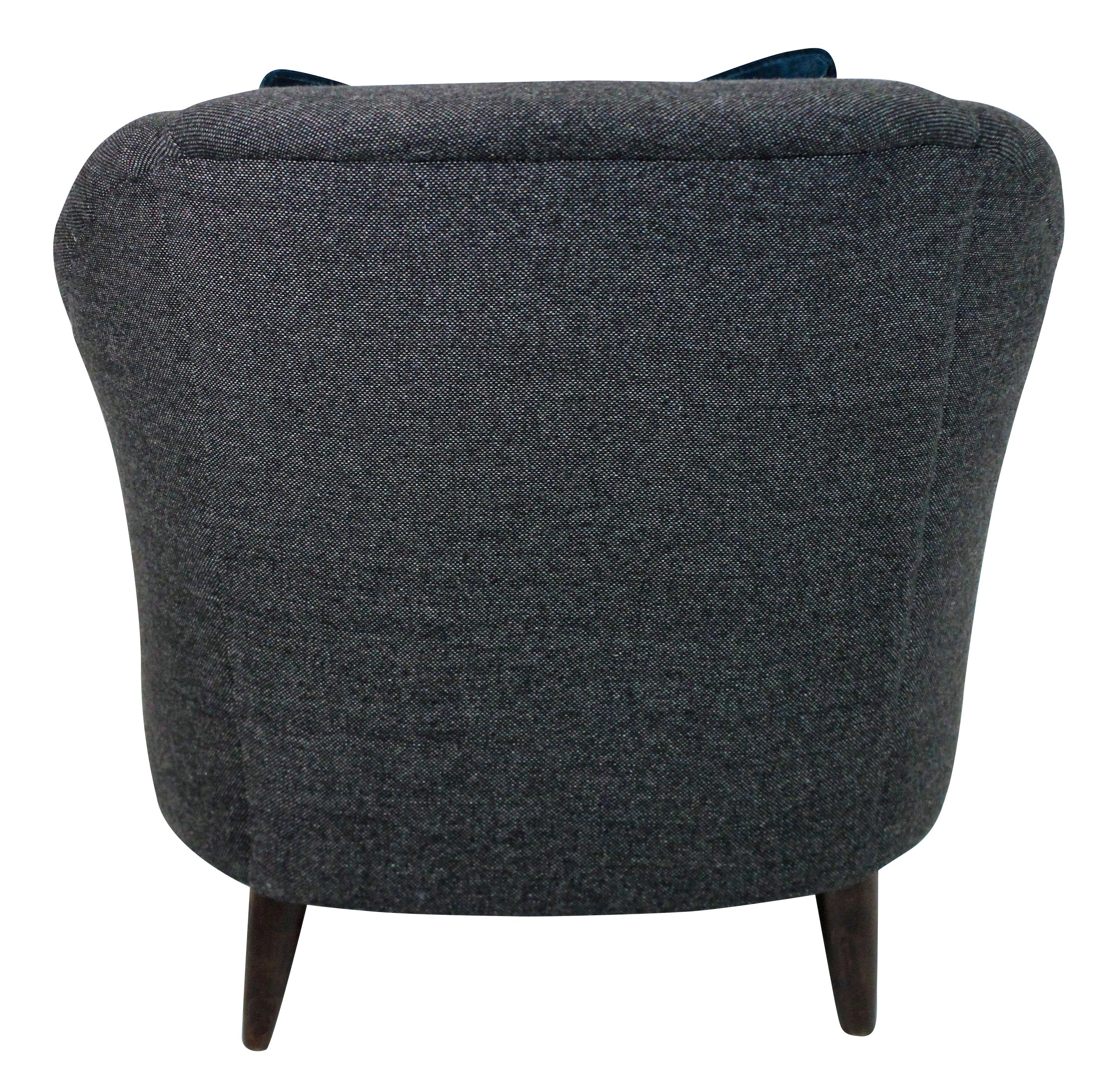 A pair of generous scale sculptural armchairs by Ulrich. Newly upholstered in dark grey wool.