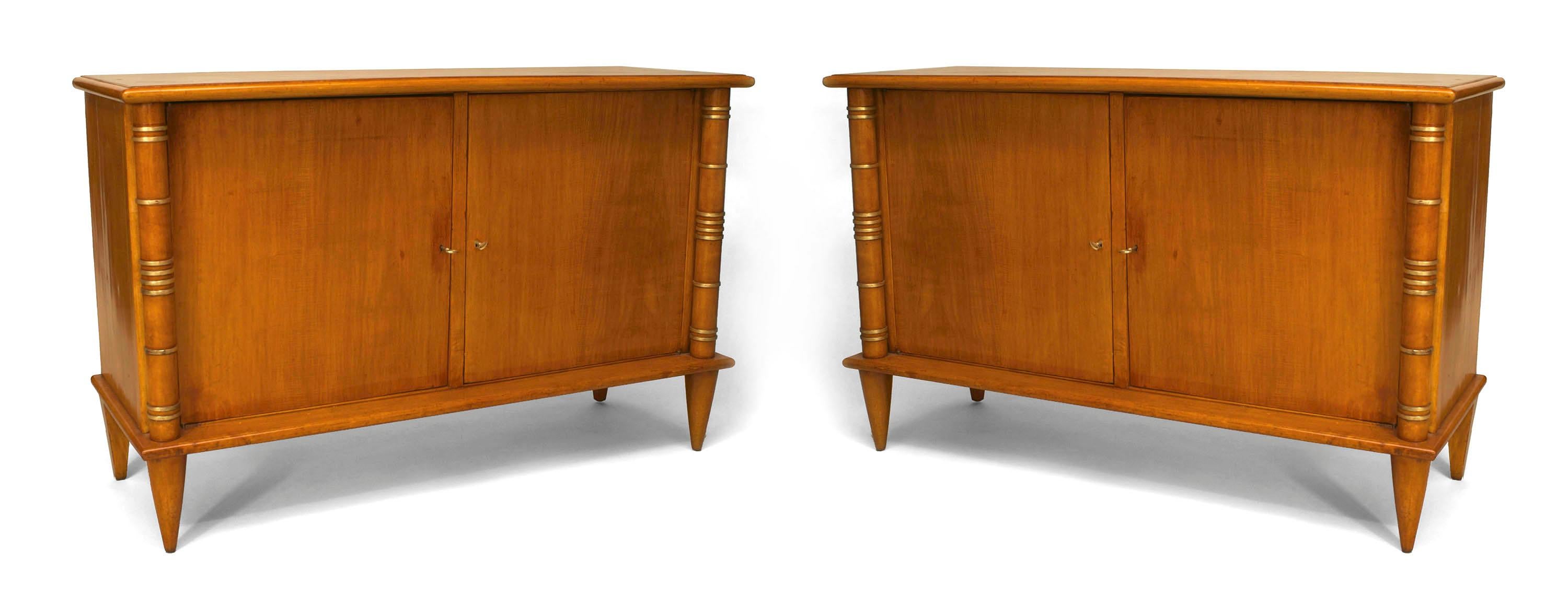 Attributed to French Art Deco designers Maurice and Leon Jallot, each rectangular sycamore commode rests upon four tapered conical legs and features two doors flanked by column sides decorated with gilt trimmed rings.


Maurice Jallot was born in