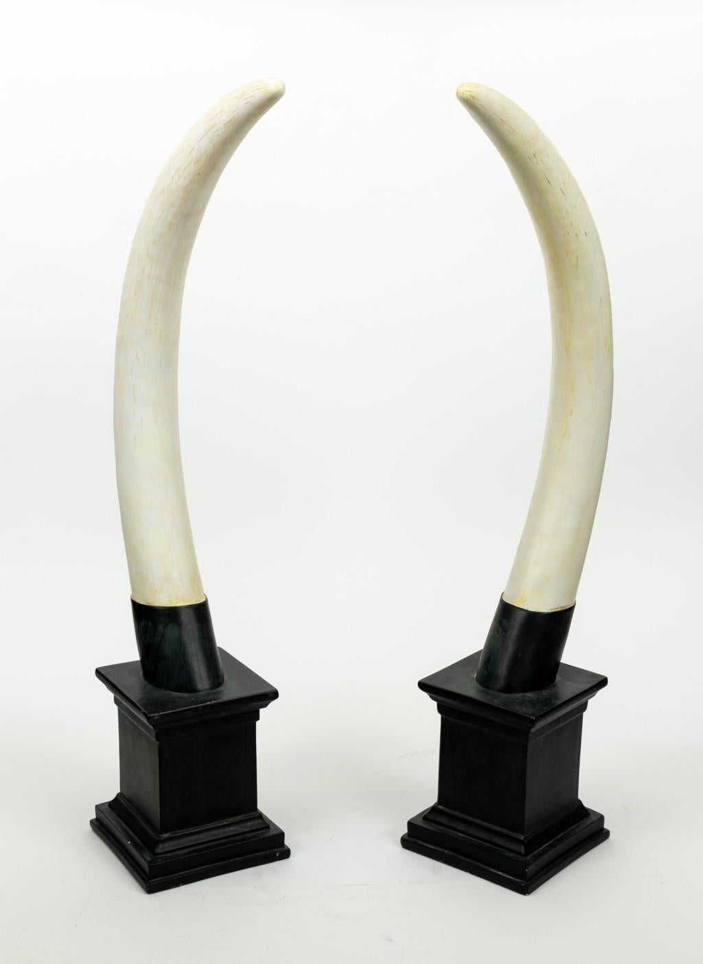 Pair of composition horns on stands. Please note of wear consistent with age.