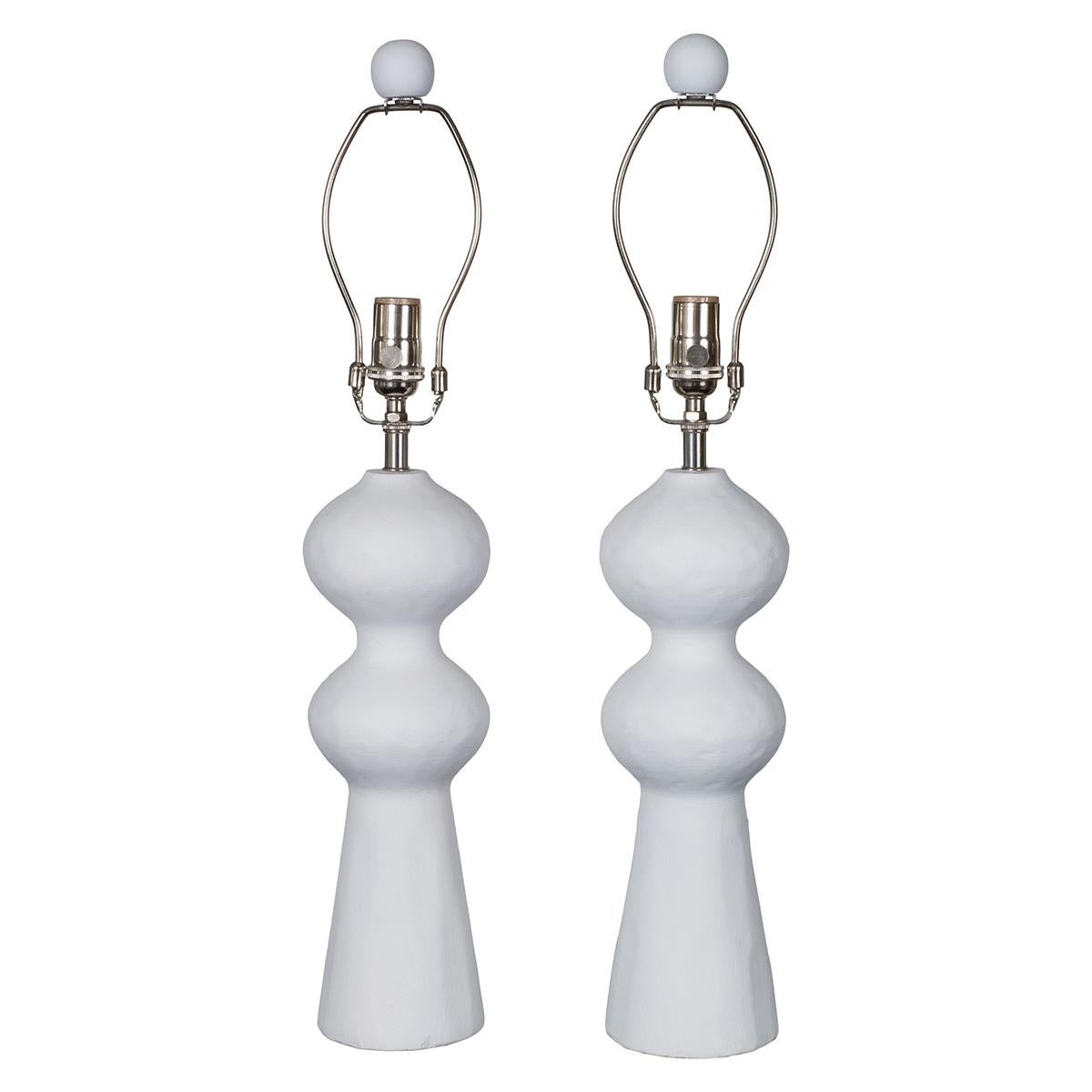 Pair of sculptural composition table lamps with organic form and matching finial.