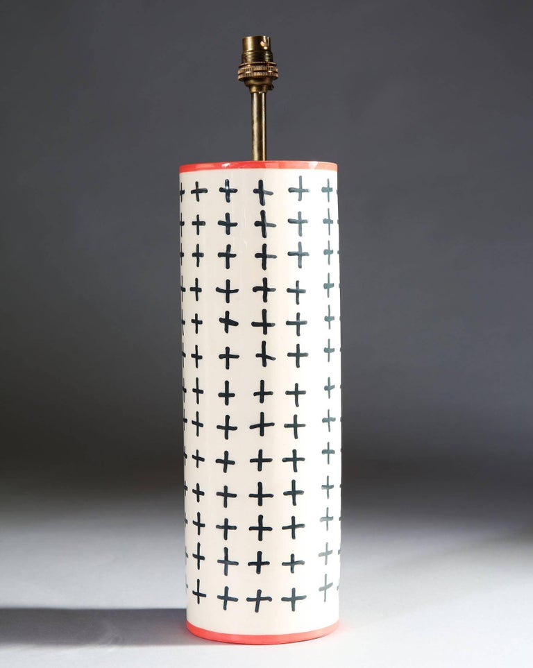 A pair of cylindrical Studio Pottery vases with a white glaze and black geometric motif, with contrasting pink rims, now converted as lamps.

Currently wired for the UK. Please enquire for rewiring services.

Please note: lampshades not included.