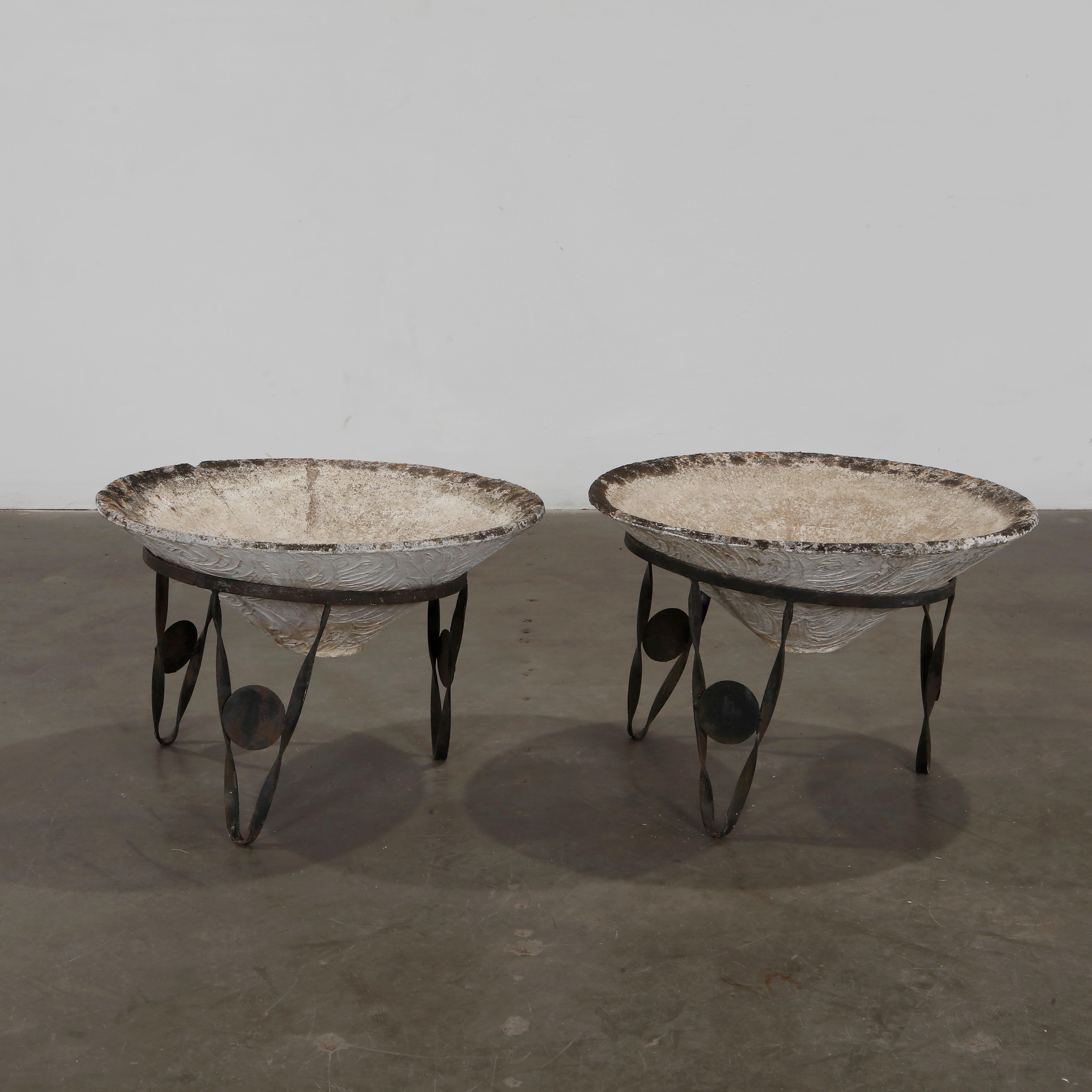 Pair of elegant conical bowls resting on sculptural iron bases. A classic of mid-century French garden design. Height: 19.6 in. Diameter: 27 in.