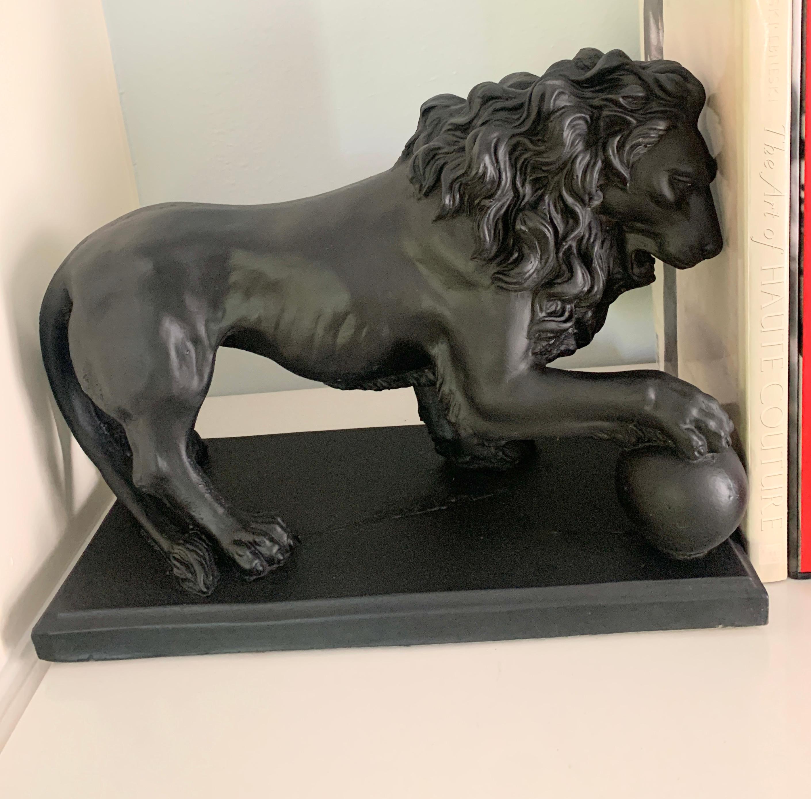 A wonderful and very heavy pair of Lions (37 Pounds ea>)in Black with a ball under foot. The pair are wonderful flanking a fireplace, outdoor garden area or perhaps in the den. They have been repainted black and will hold up well inside our outside.