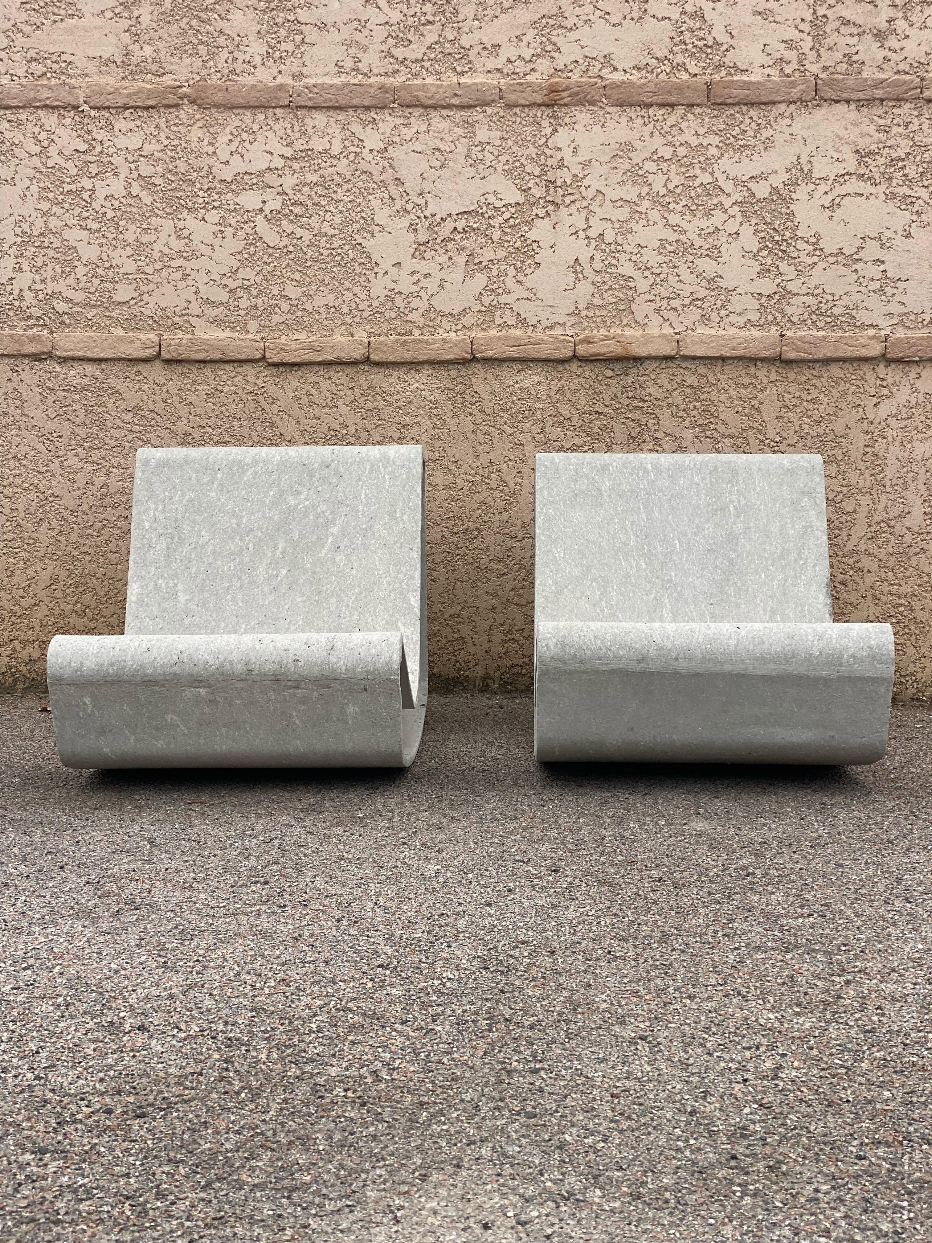 Two concrete beach or pool lounge chairs.

Loop model created by designer Willy Guhl in the 1950s.

The Loop chair features a single sheet of seats and backs and is suitable for indoor and outdoor use.

Minimalist design, functional and