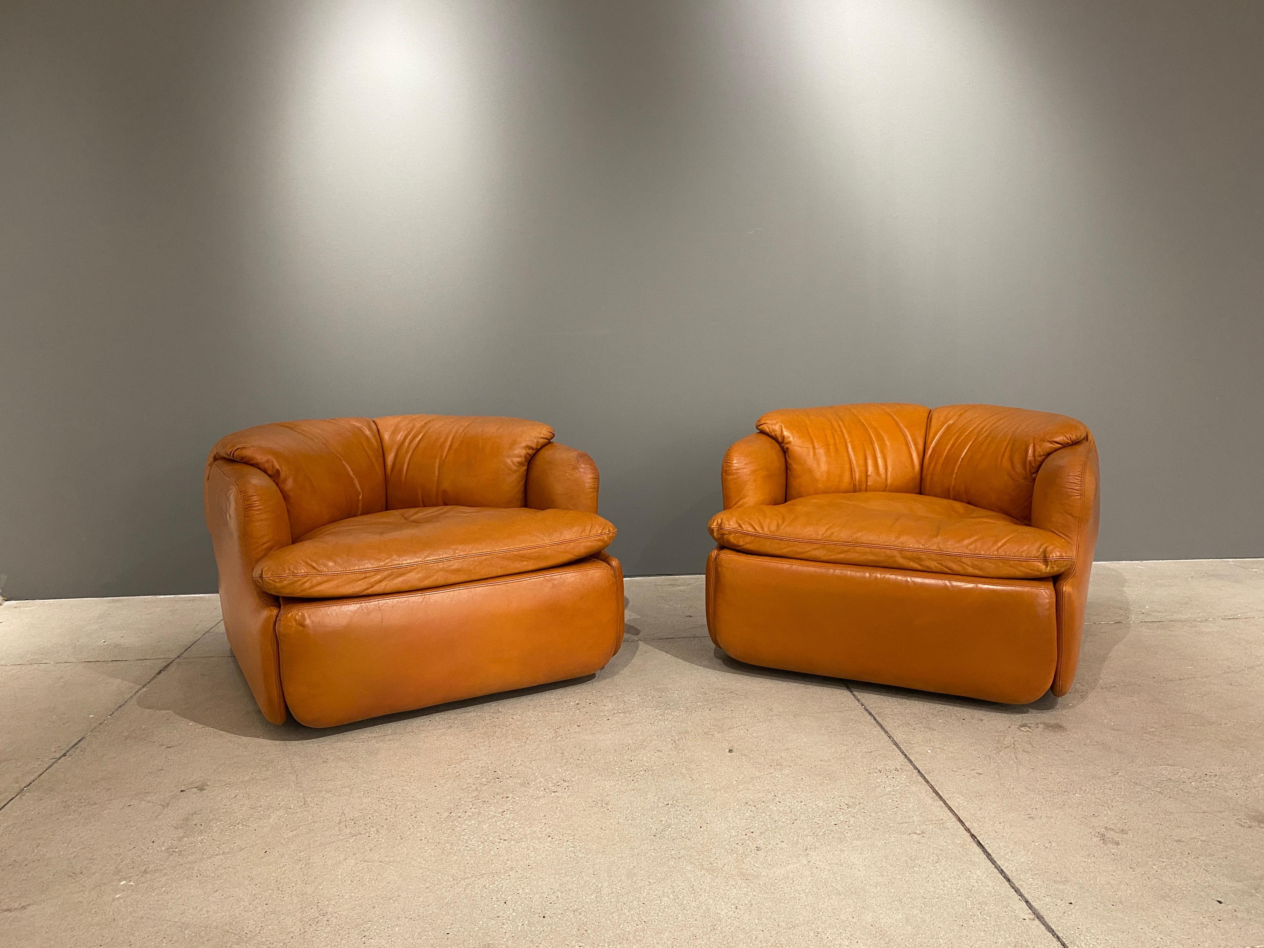 A pair of armchairs in leather designed by the Alberto Rosselli. These chairs are so inviting, so comfortable and in great shape. The unique design of the cushions which nestle in the frame make it a work of art. The leather is in good shape with a