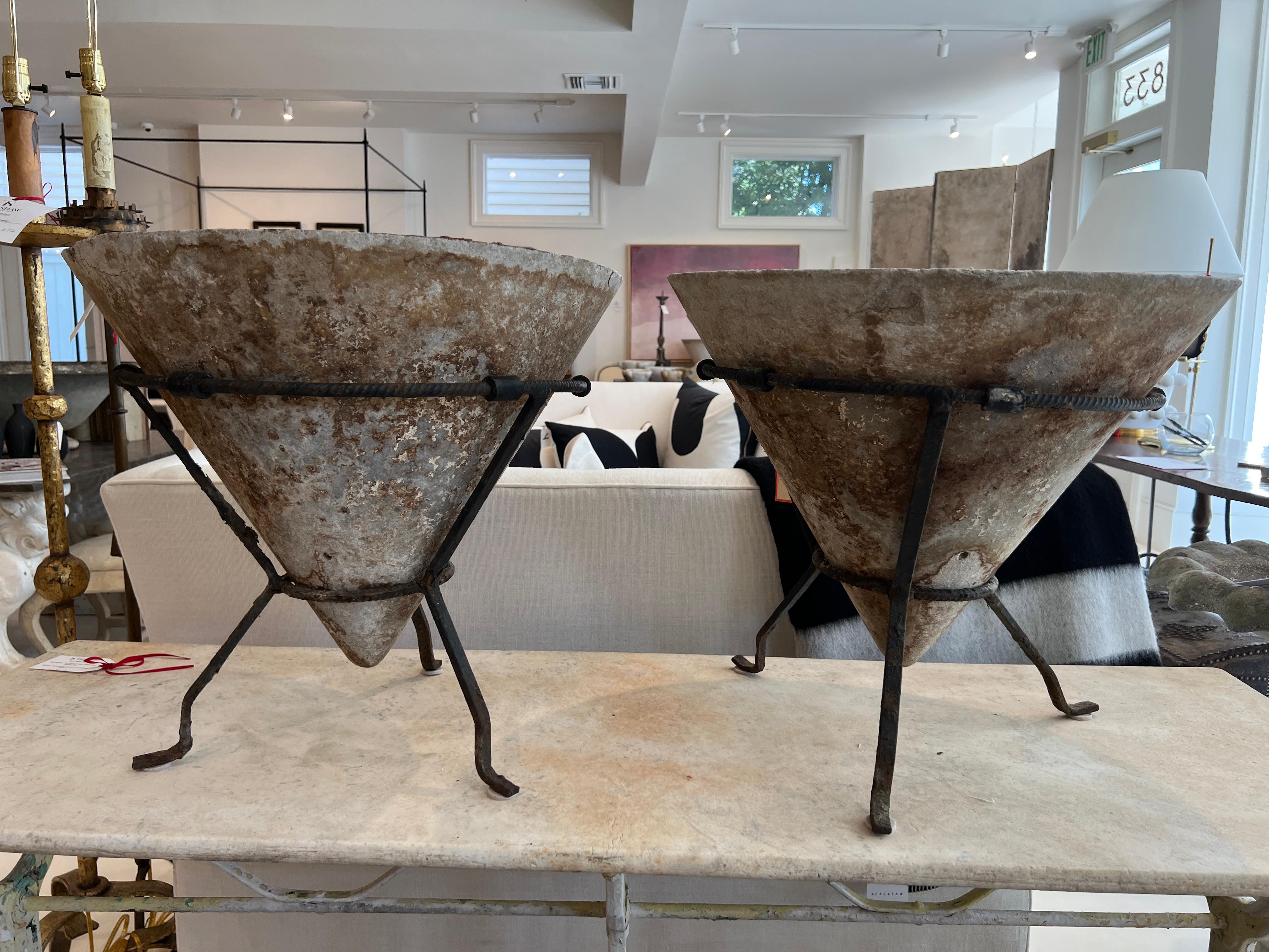 A pair of very unusual conical planters in customized iron stands.