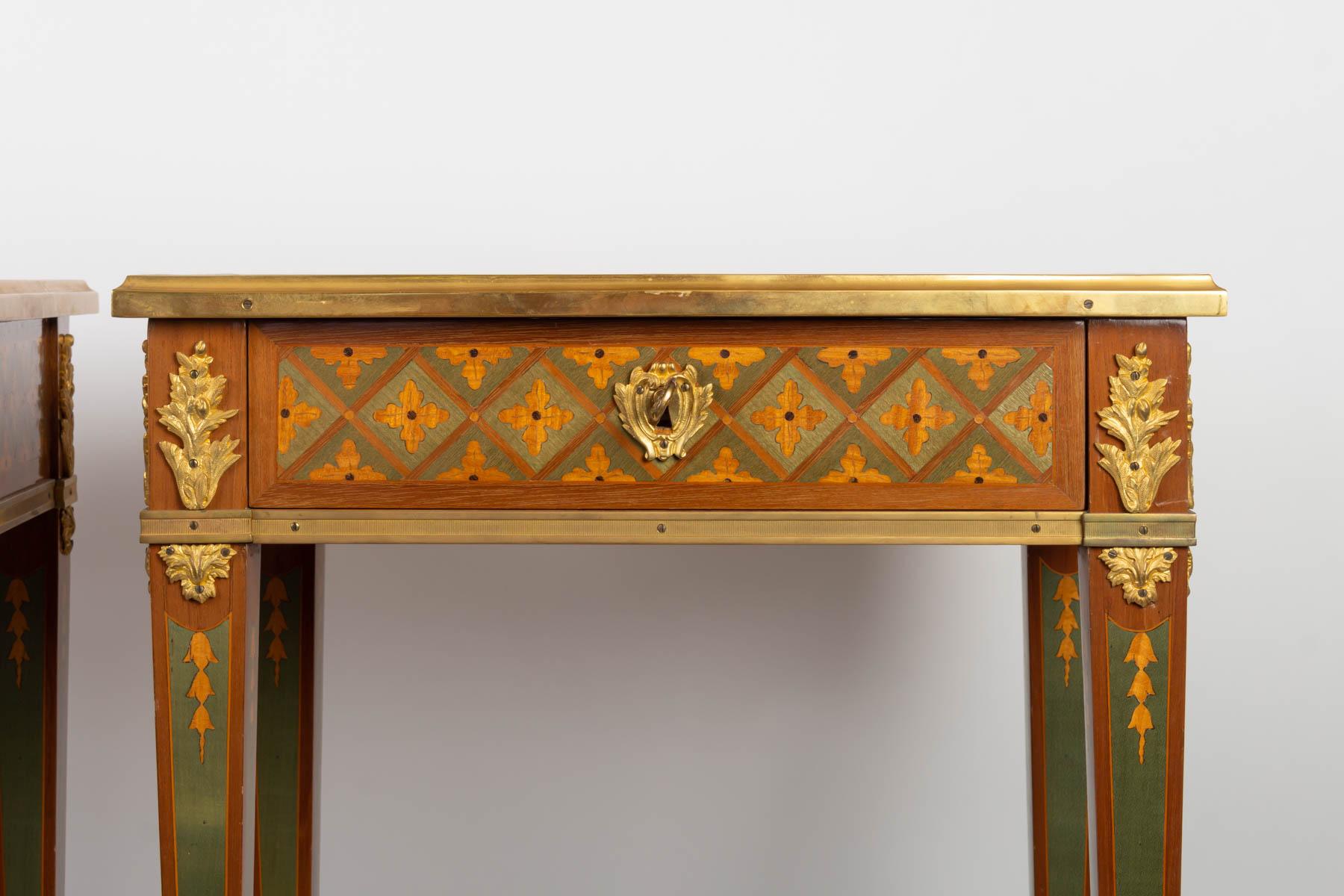 Pair of Louis XVI style consoles in precious wood and golden bronze marquetry

Measures: H 70cm, W 49cm, D 35cm.