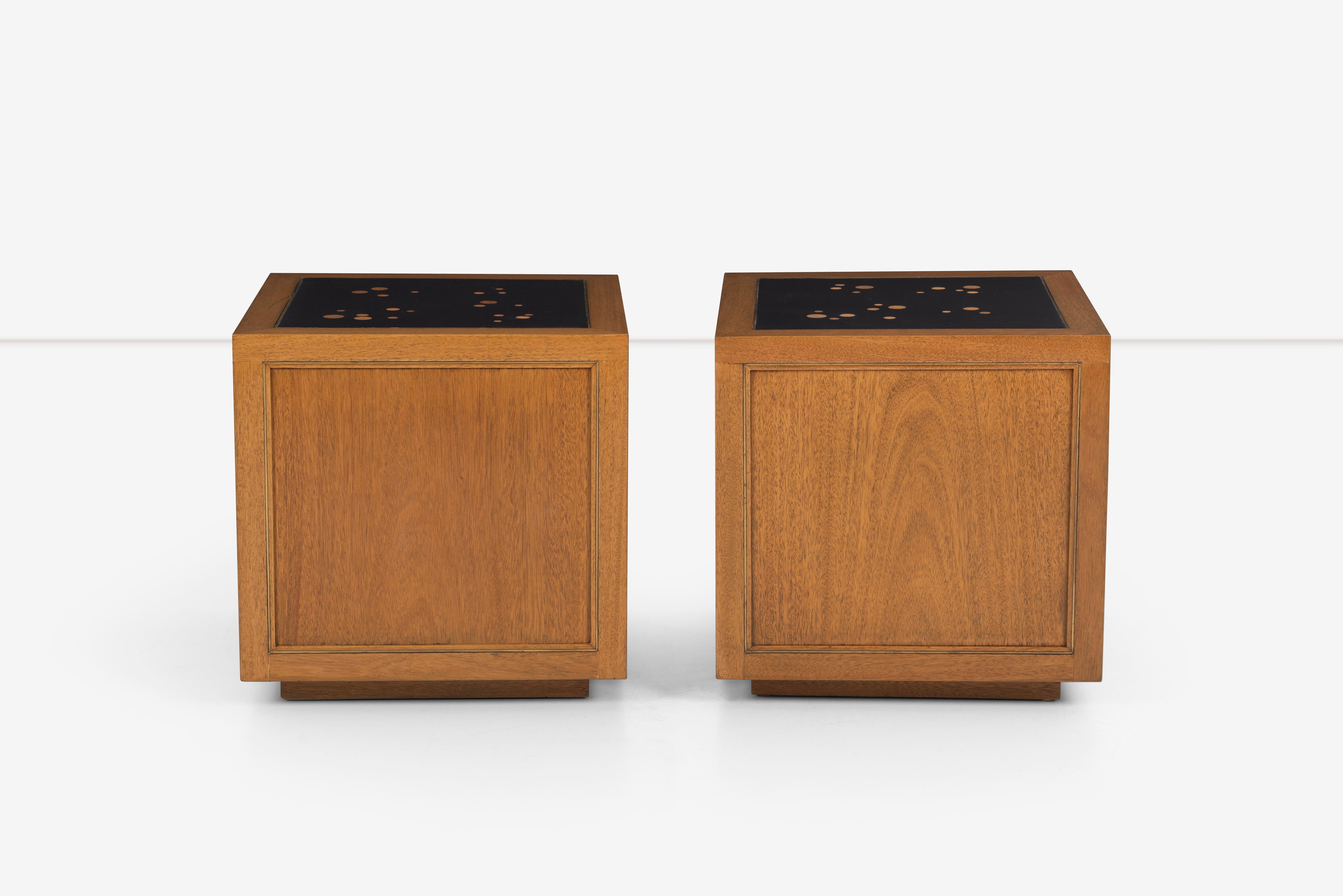 Pair of cube shaped end tables on plinth bases. Mahogany body and brass inlay framing on every side. Black lacquered wood top with 
