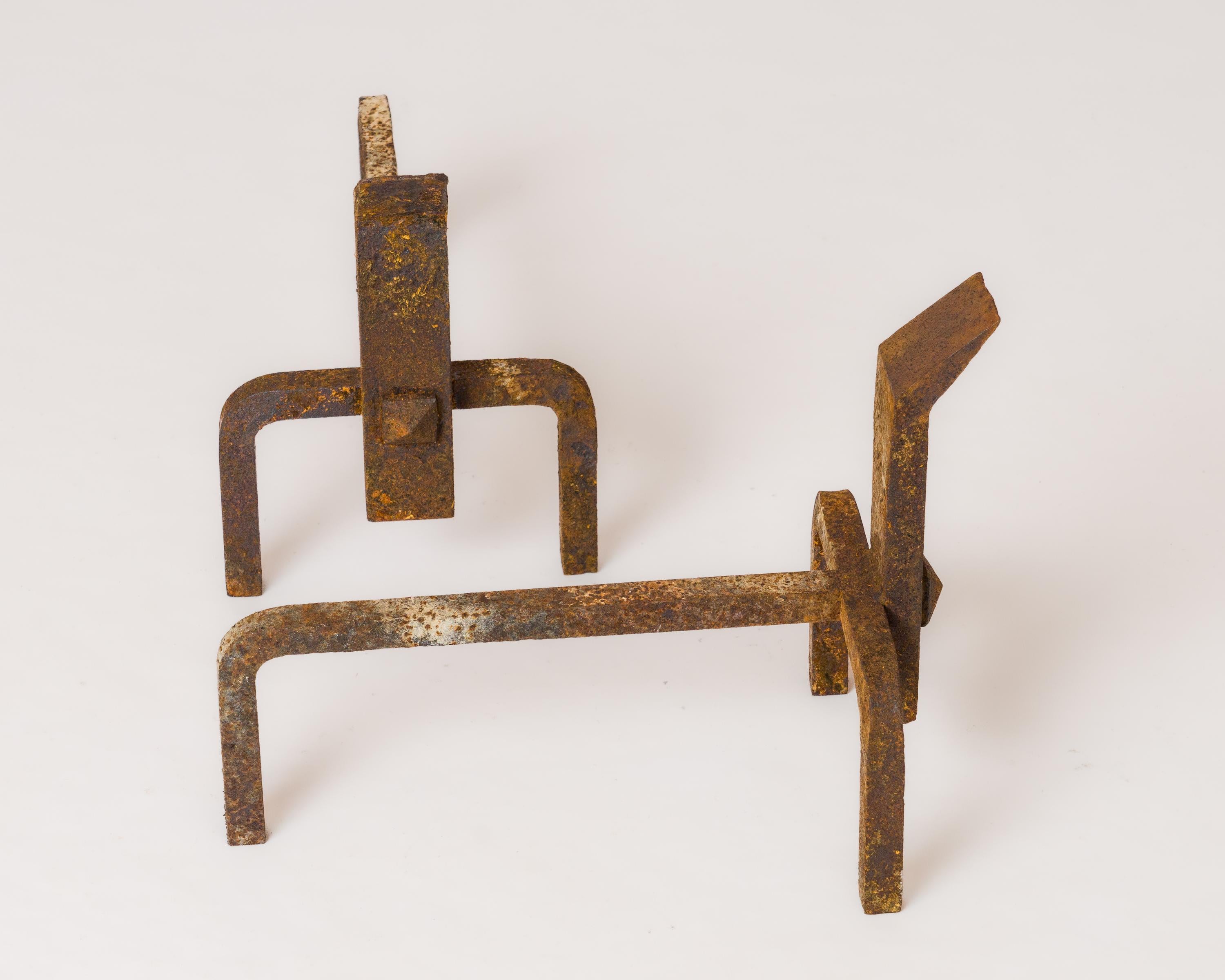 Graphic constructivist wrought iron andirons with tappered end. In fair vintage condition. Can be partially polished or fully sanded (at extra charge).
These andirons will ship from France and can be returned to either France or to an upstate NY