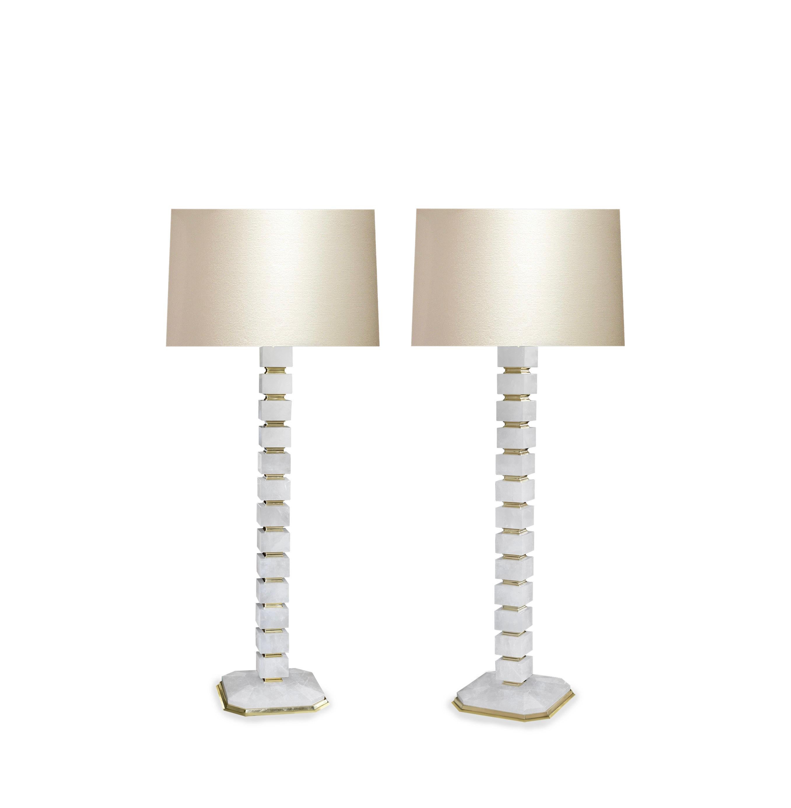 Pair of contemporary block form rock crystal lamps with polished brass base and inserted decoration. Created by Phoenix Gallery NYC.
Measure: 50in/H to the top of the rock crystal.
Each lamp installs two sockets.
Lampshade do not include.
