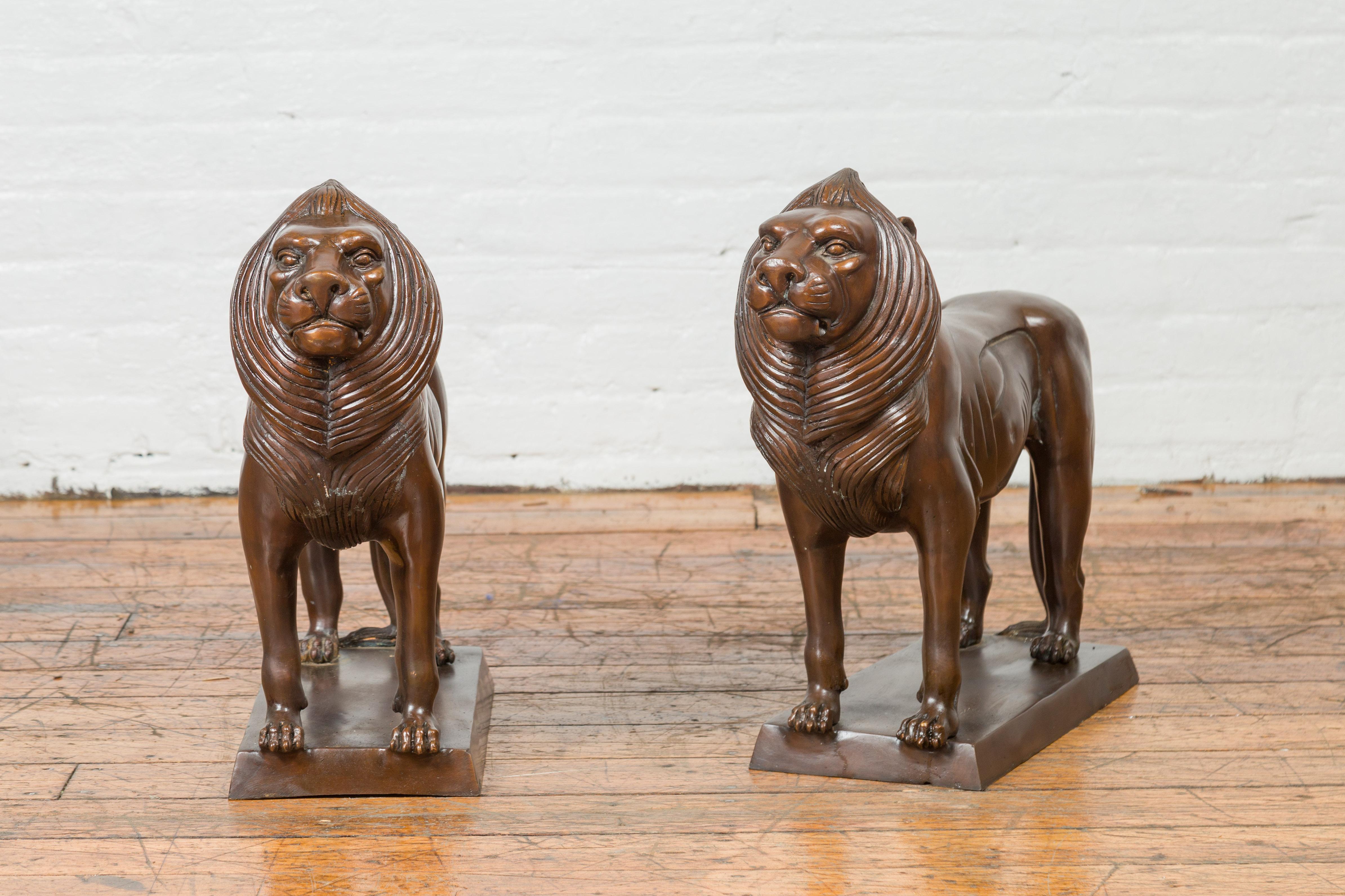 Cast Pair of Contemporary Bronze Lion Sculptures on Bases with Dark Patina For Sale