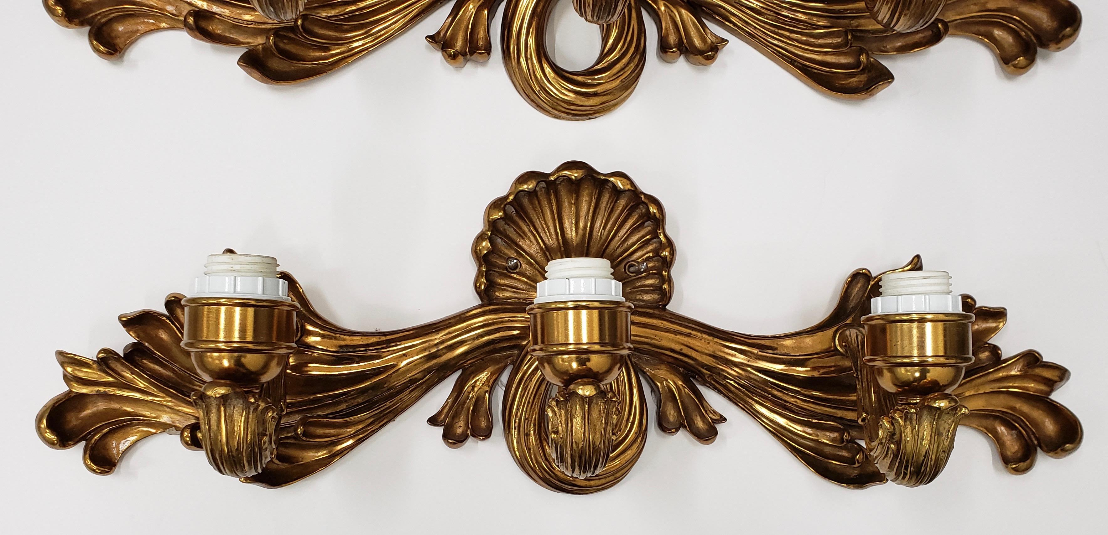 Pair of contemporary cast bronze and gilded wall sconces

Elegant pair of heavy bronze wall sconces. These are wired and ready to illuminate. No shades. No bulbs.

Each sconce measures 28 wide x 7