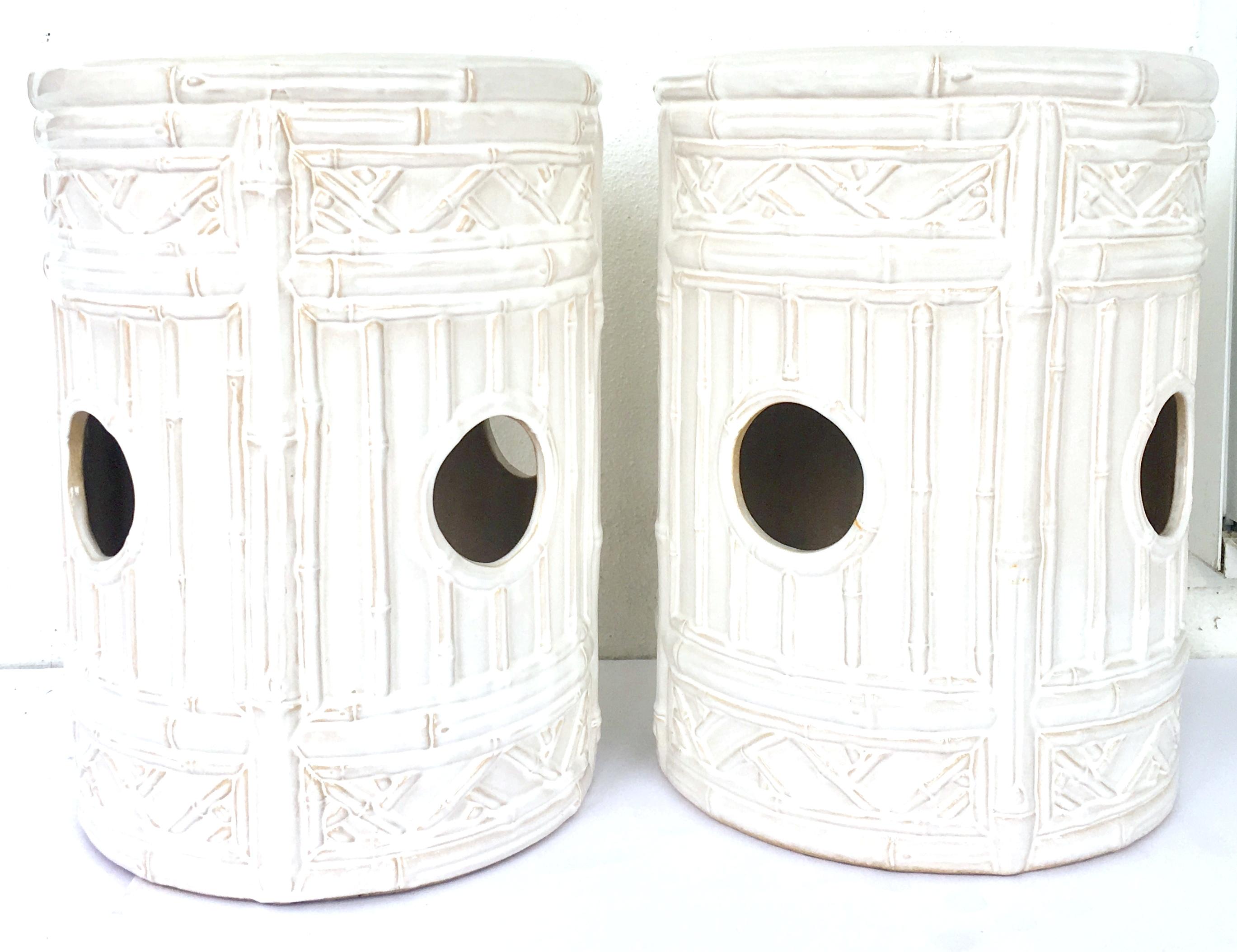 21st Century & New pair of ceramic glaze faux bamboo garden stools. These Hollywood Regency style garden stools are executed in off-white with camel tone detail and each feature cut-out handle detail. Signed on the underside, emissary made in China.