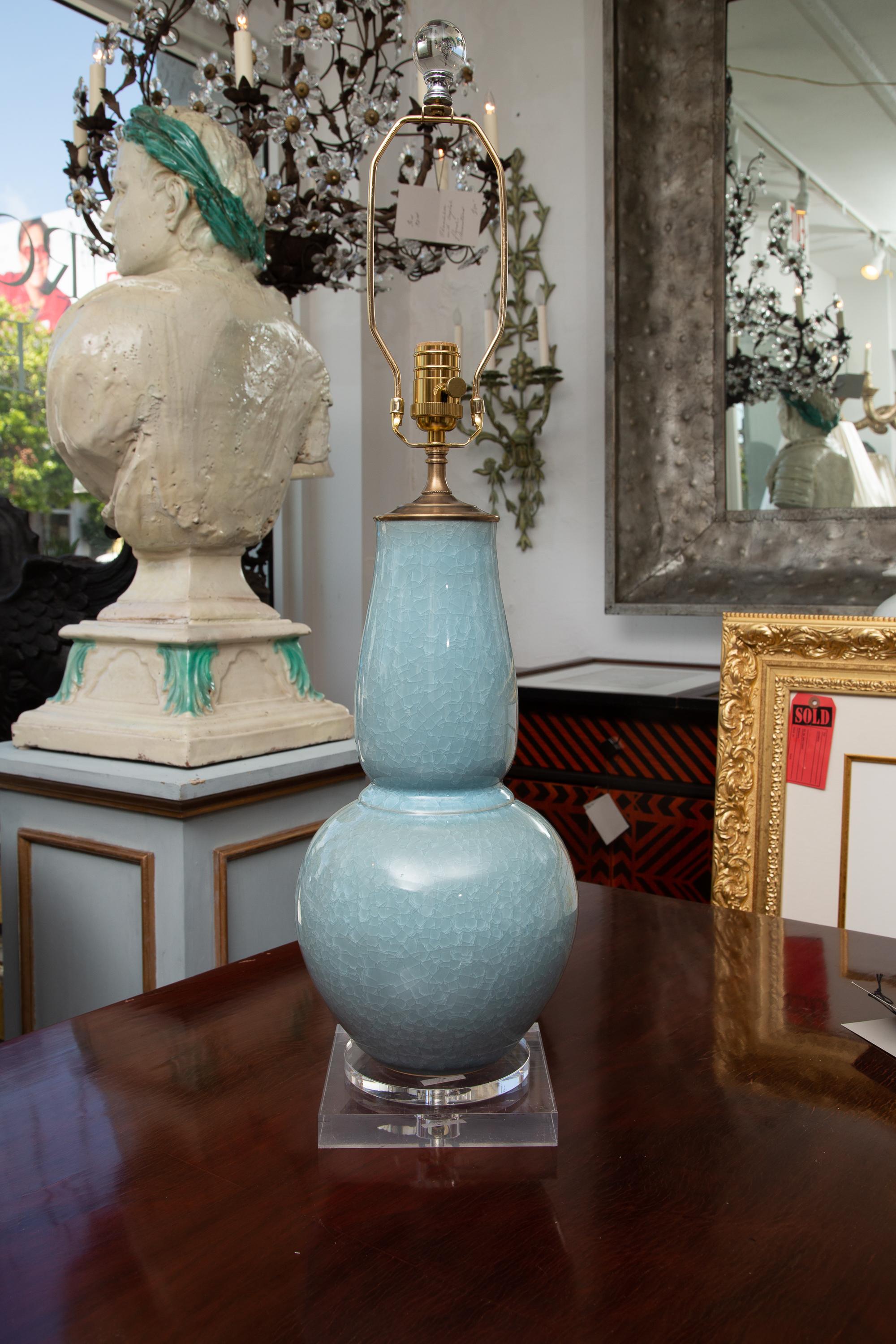This is a lovely pair of Chinese dark crackled celadon vases converted to table lamps, situated on a square plexiglass base. 20th century.