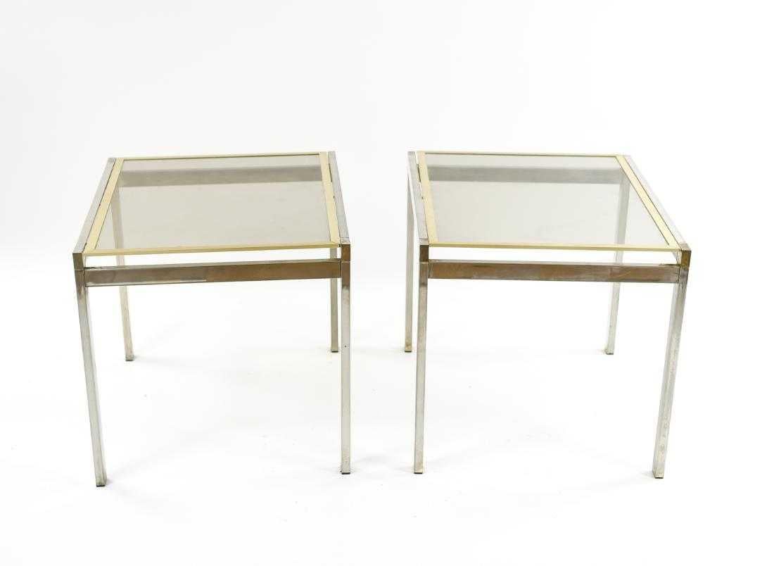 The pair of contemporary end or side tables are composed of chrome frames and legs, and glass tops framed in brass that are inset into the chrome frames. The glass and brass tops are removable.