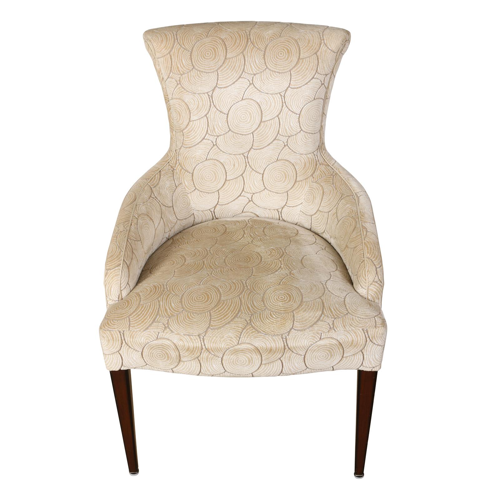 A vintage pair of contemporary shaped chairs upholstered in modern cream colored velvet with a geometric velvet circular design on wood legs.