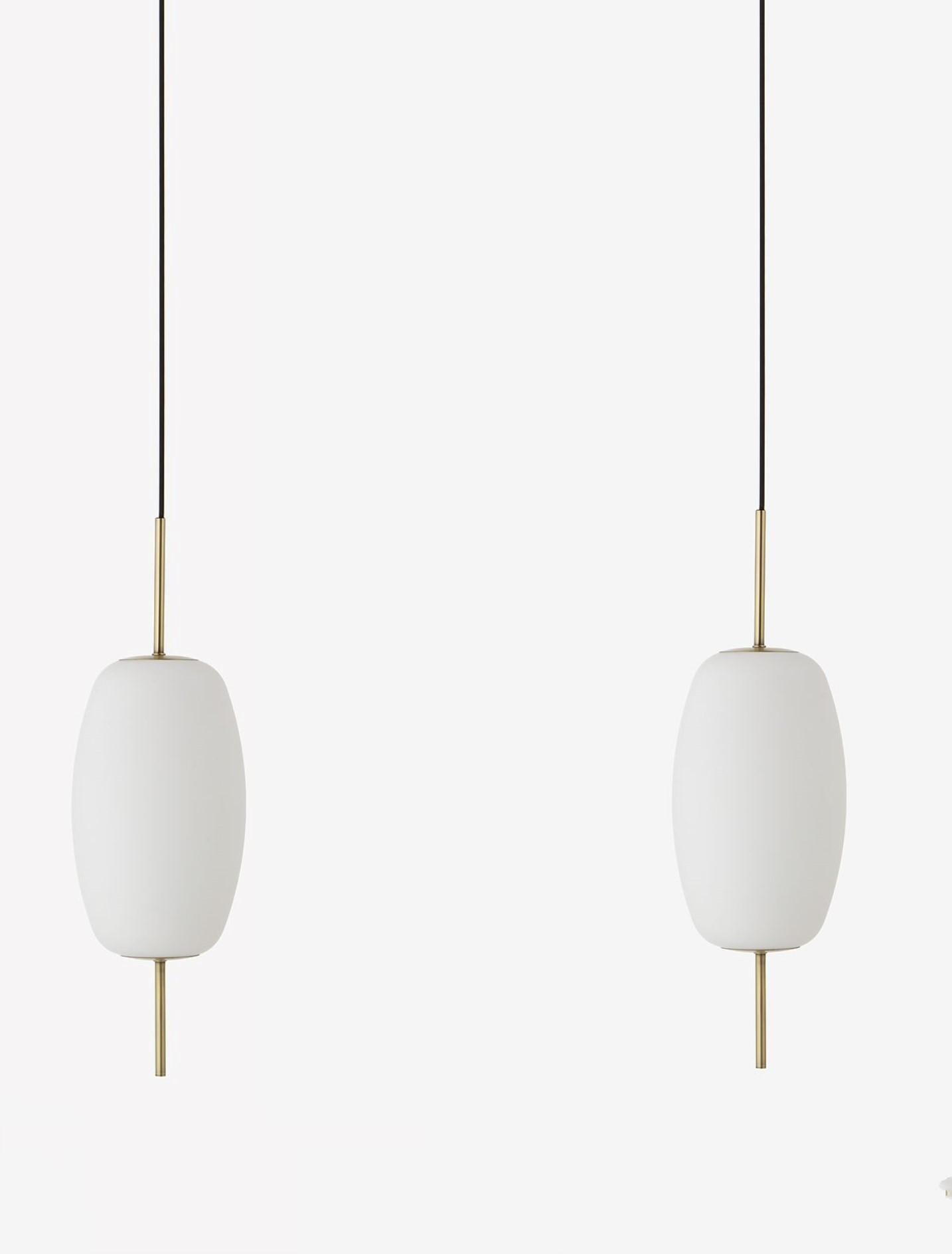 A pair of outstanding danish design light pendants, satin glasss, brushed brass mounts and canopy with black kord, Denmark, 2020.
One Edison E-14 light socket for a screw bulb up to 40watt.
Measures: 
Height of pendant with brass and canopy: 25