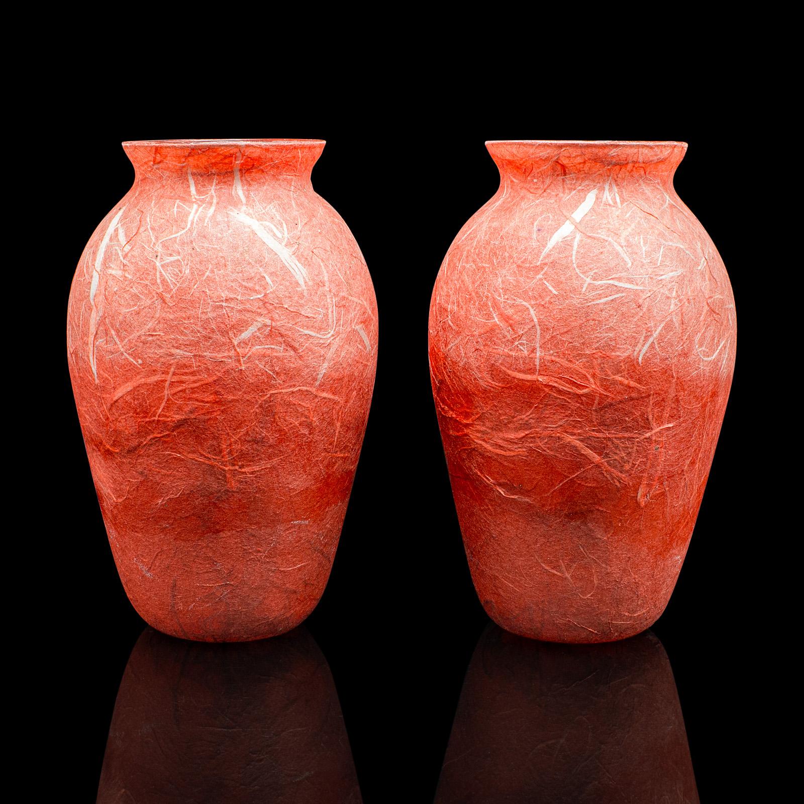 
This is a pair of contemporary decorative flower vases. An English, art glass and straw silk posy sleeve by Margaret Johnson.

Striking colour with a fascinating textured finish
Displaying a desirable, contemporary appearance
Colourful glass with a