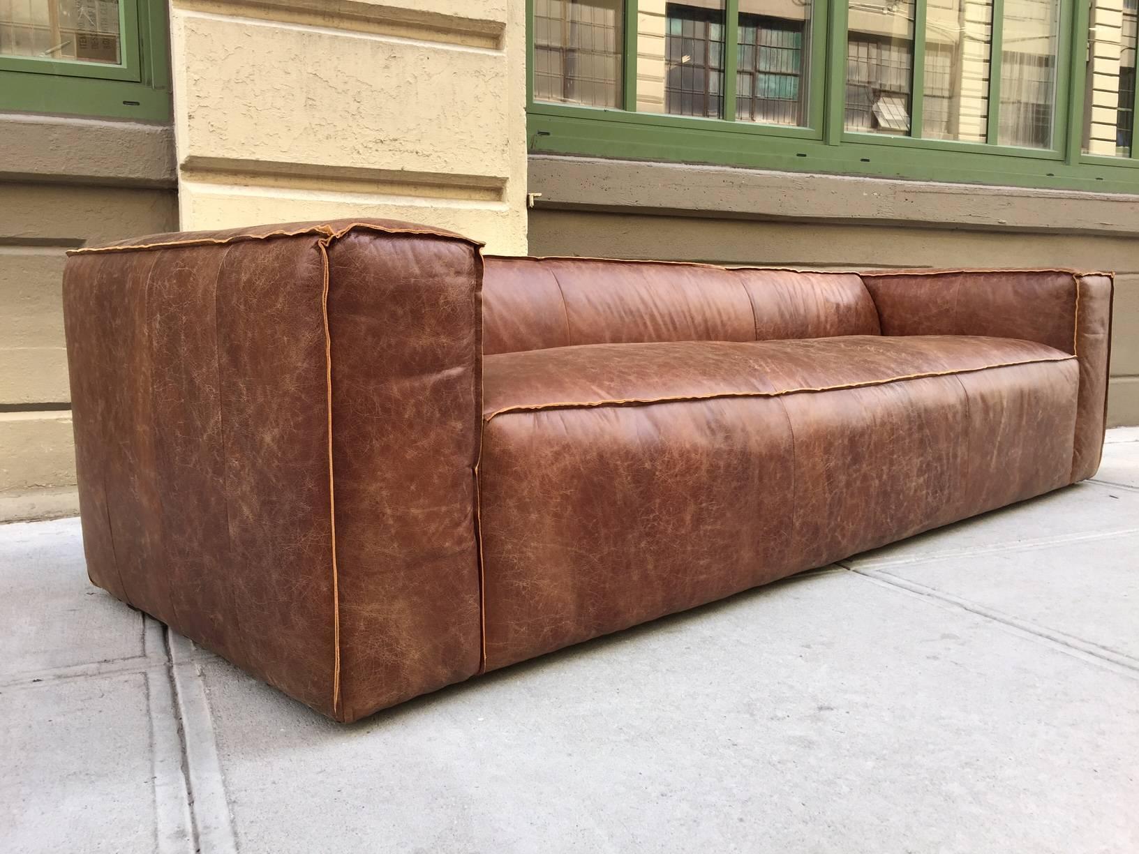 9 feet contemporary distressed brown leather sofa with Cerused oak feet.