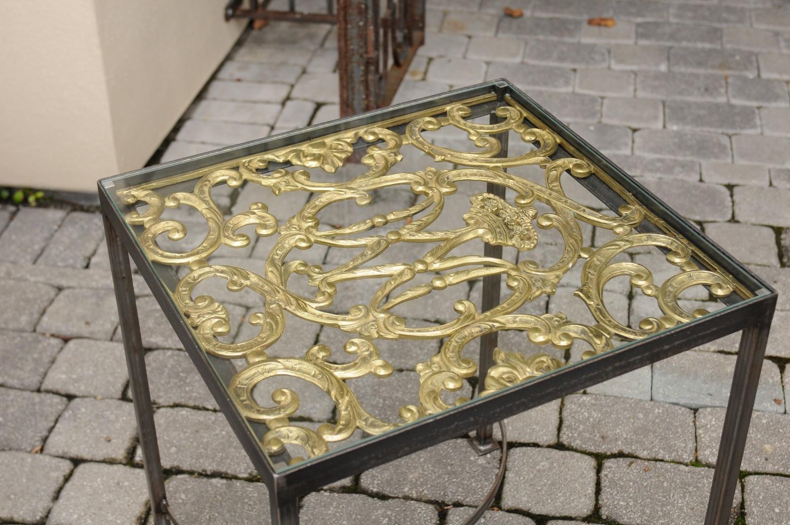 A pair of contemporary end tables made of 19th century English firescreen panels mounted on new custom-made steel bases. Each of this pair of end tables features a rectangular top made of English 19th century brass firescreen panels, adorned with an