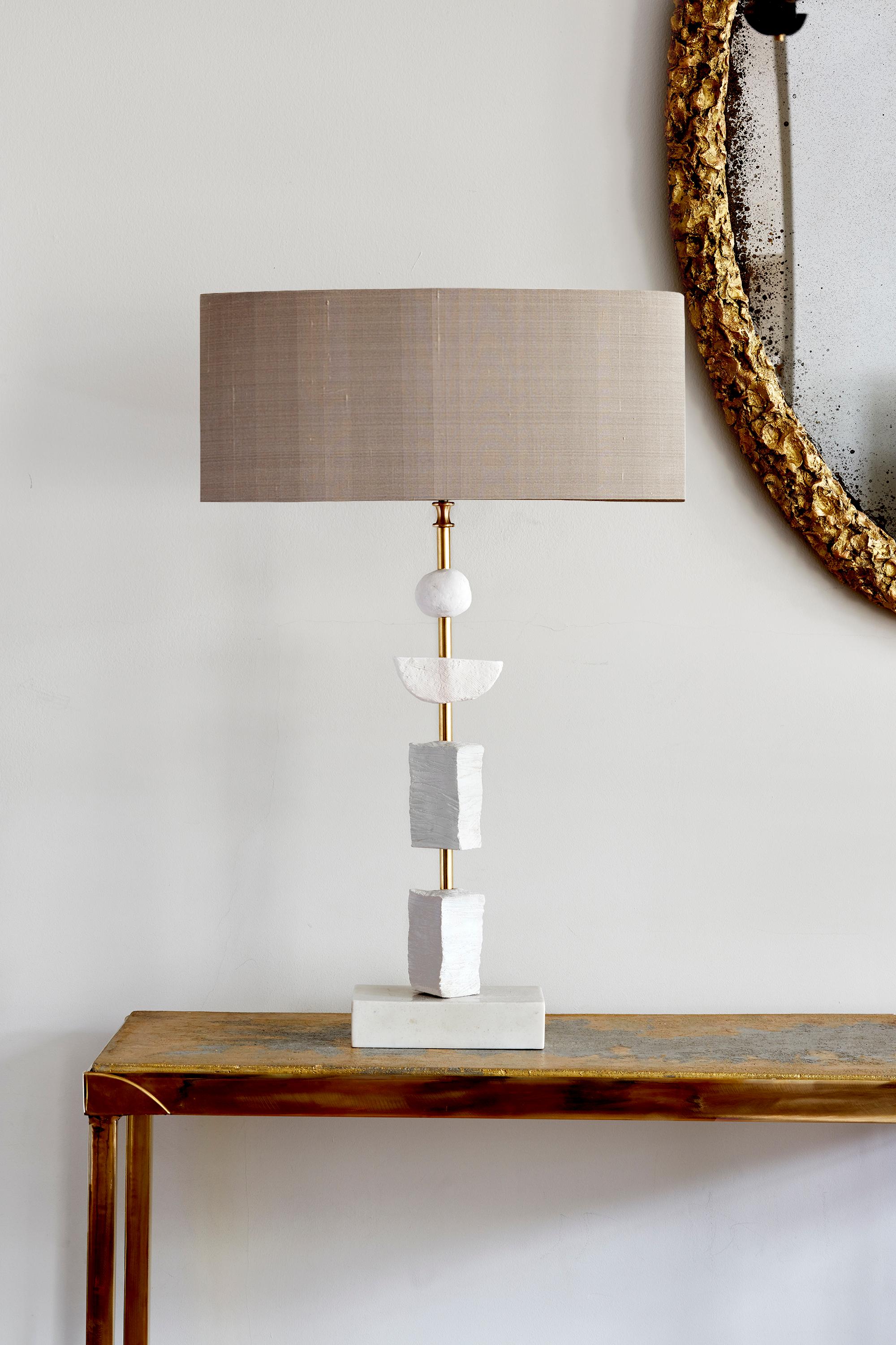 These sculptural contemporary Margit Wittig table lamps are mounted on rectangular slate bases and feature multiple white resin handcrafted cuboids, spheres and semi-circles with organic surface textures.
Interspersed with the shapes are brass