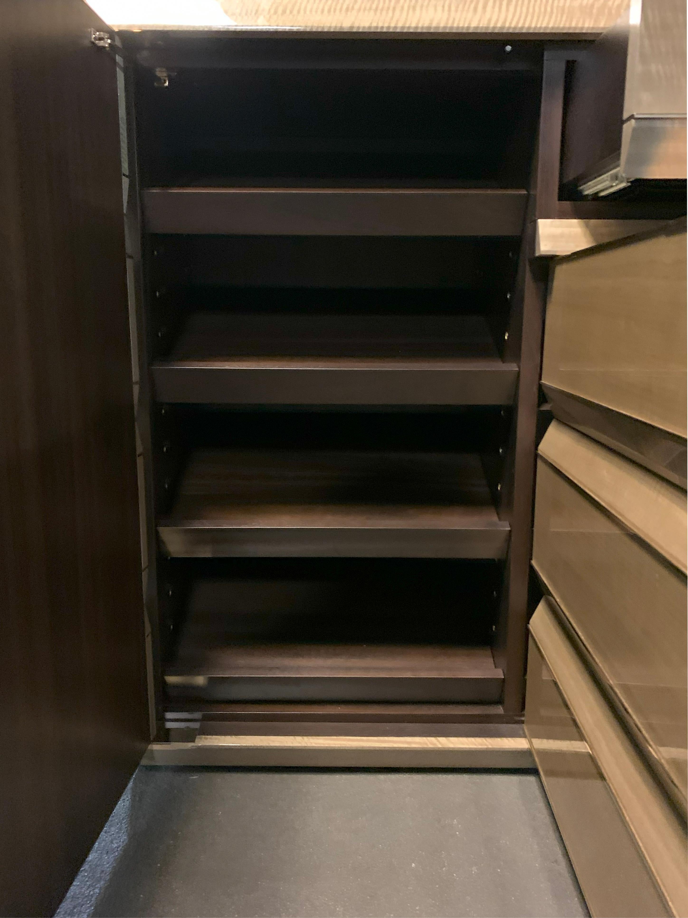 A  pair of shoe storage cabinets, handcrafted by acclaimed London-based furniture makers Kaizen London in 2014. Designed as part of a commission for a formal entrance hall, these substantial credenza-style cabinets combine architectural geometry