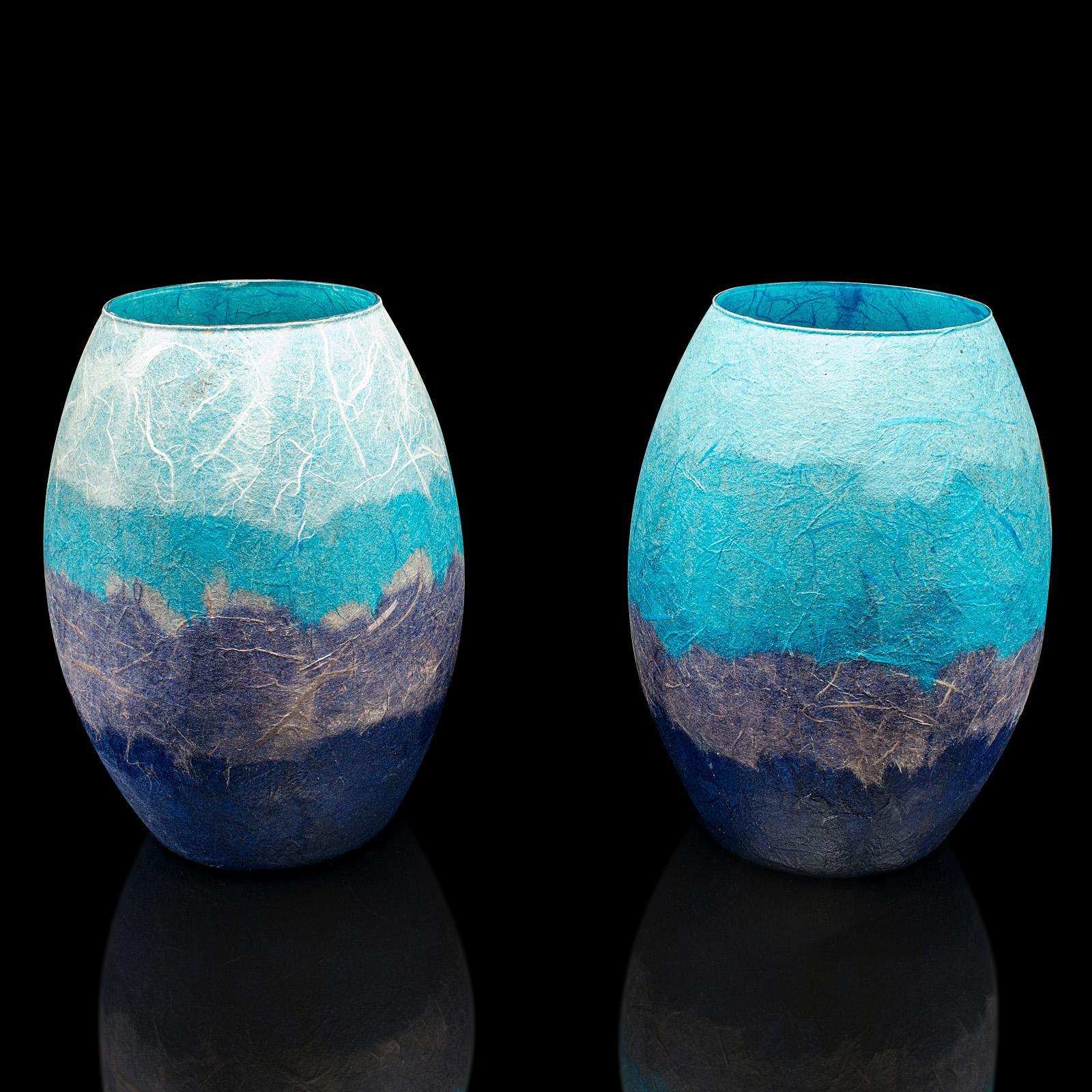 
This is a pair of contemporary flower vases. An English, art glass and straw silk baluster urn by Margaret Johnson.

Eye-catching hues with an unusual decorative finish
Displaying a desirable, contemporary appearance
Silk straw covered glass with a
