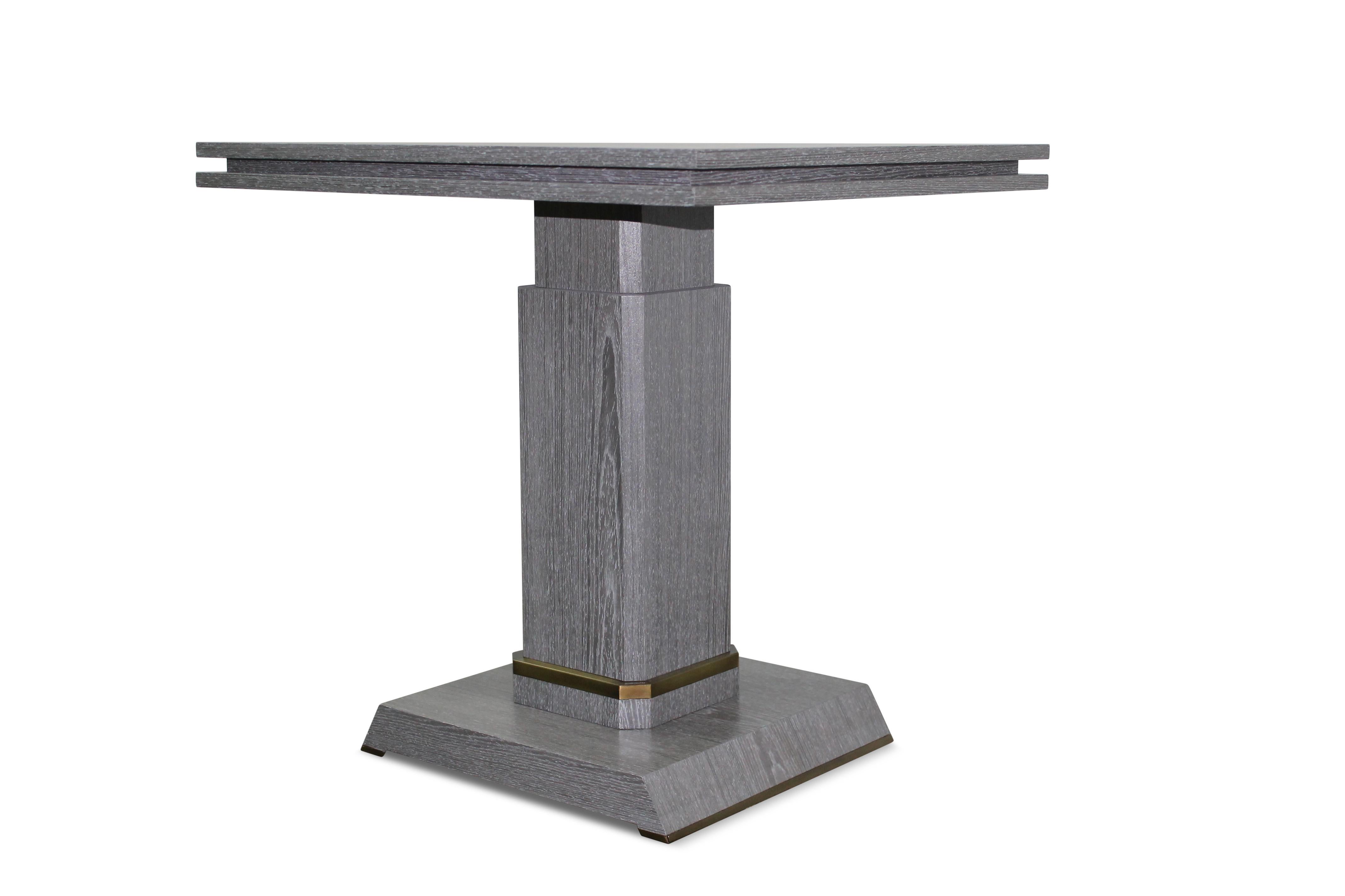 This pair of side tables from Costantini Design in cerused oak tables with bronze detailing at base and feet are in stock and ready for immediate delivery.  

 