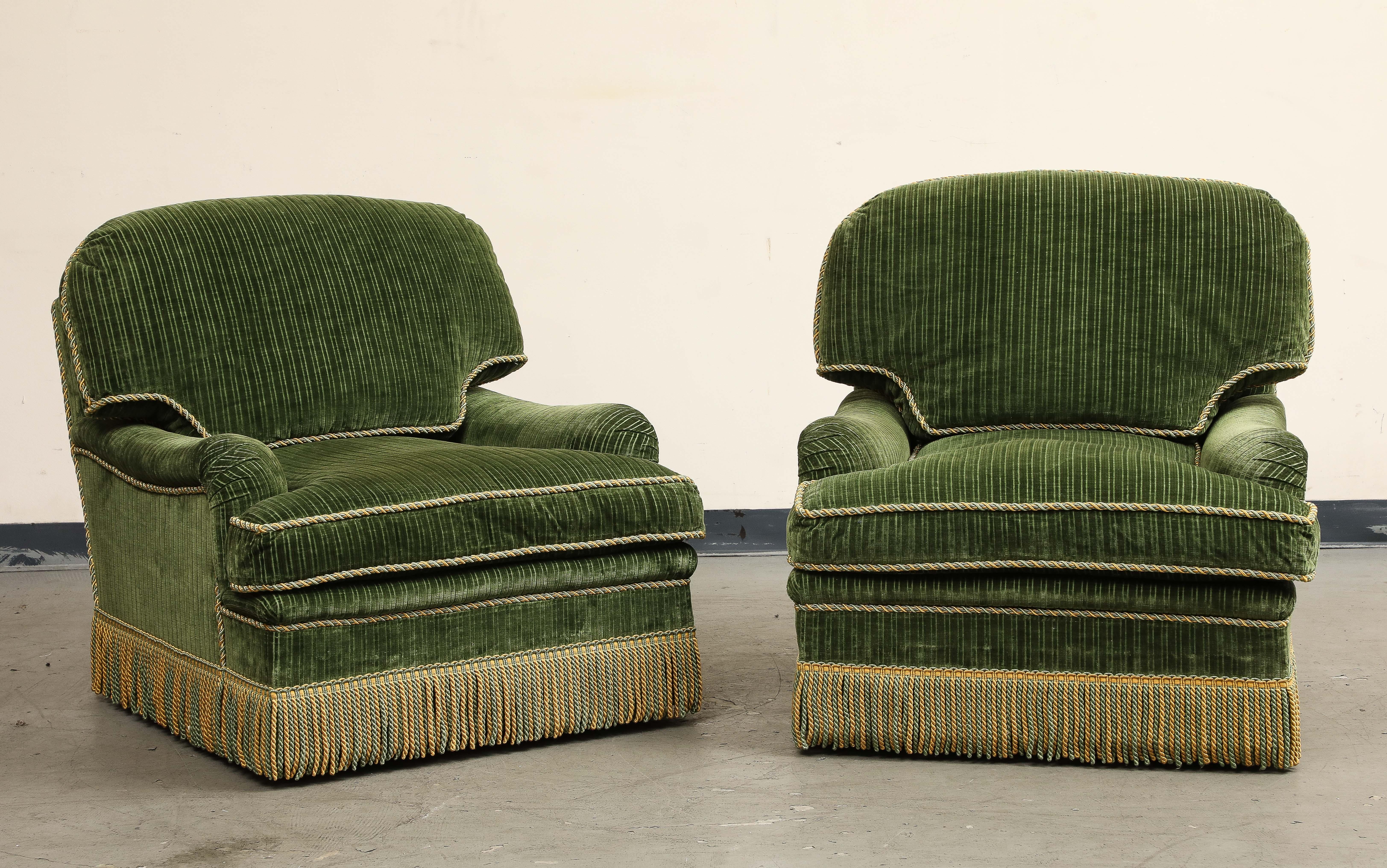 A pair of contemporary plush green ribbed velvet swivel club chairs by Thomas Britt, trimmed with green and gold silk rope seams and tassels.

Additional dimensions: 
SH 18