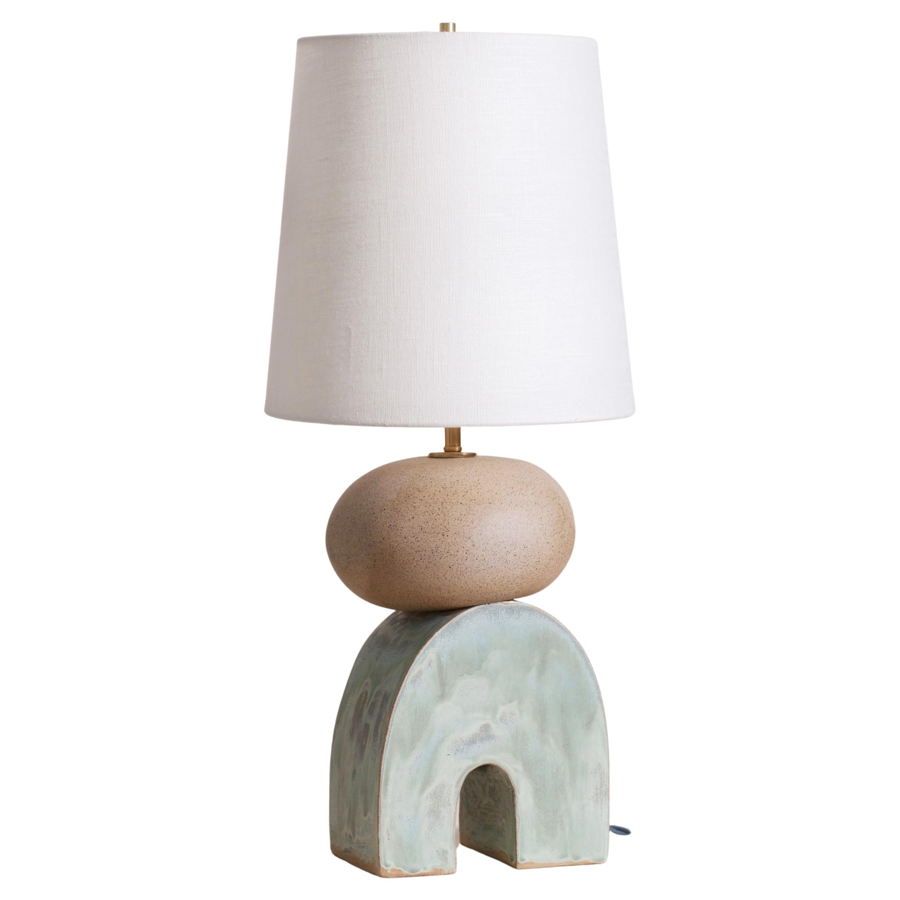 Pair of one of a kind ceramic lamps, thrown on the potters wheel and assembled by hand. The lamp base is comprised of two different clay bodies and features a raw, unglazed ceramic surface to highlight the texture of natural clay contrasted with a