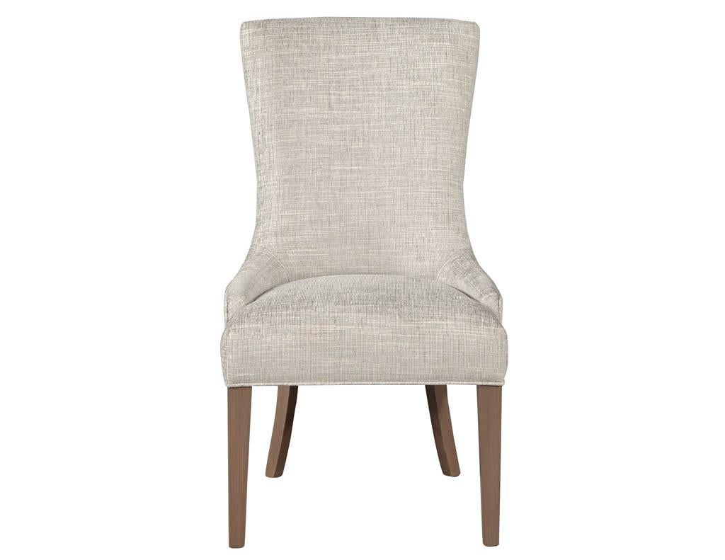 Pair of contemporary high back accent chairs. Designed with a deep seat and concave ergonomic back. Featured in a textured contemporary fabric with satin natural brown legs.

Price includes complimentary scheduled curb side delivery service to the