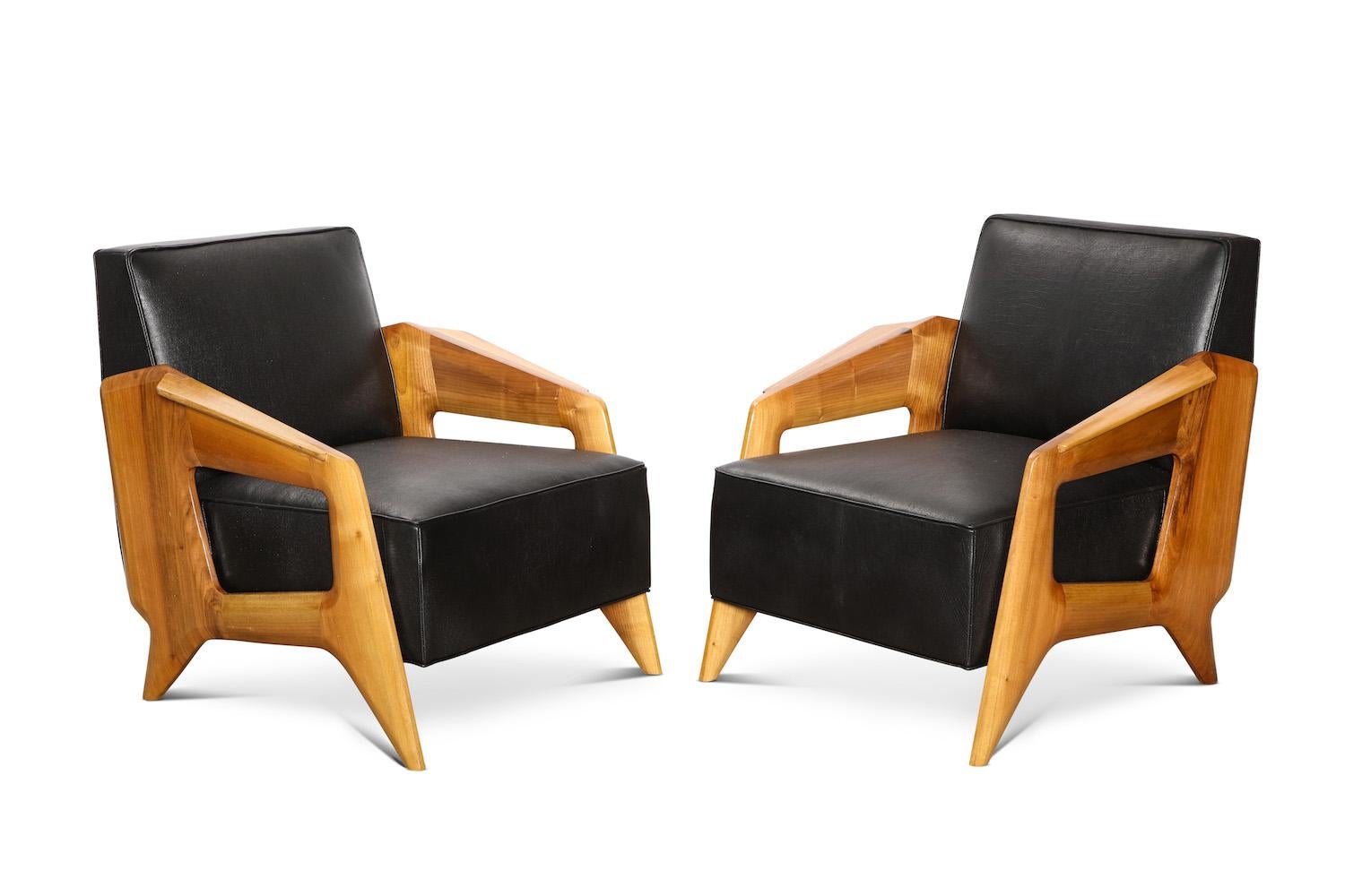 Low lounge chairs made from Italian walnut. Sculpted sides and form. Shown here with dark leather upholstery. Frames are hand made in Italy. Lead time varies depending on availability.