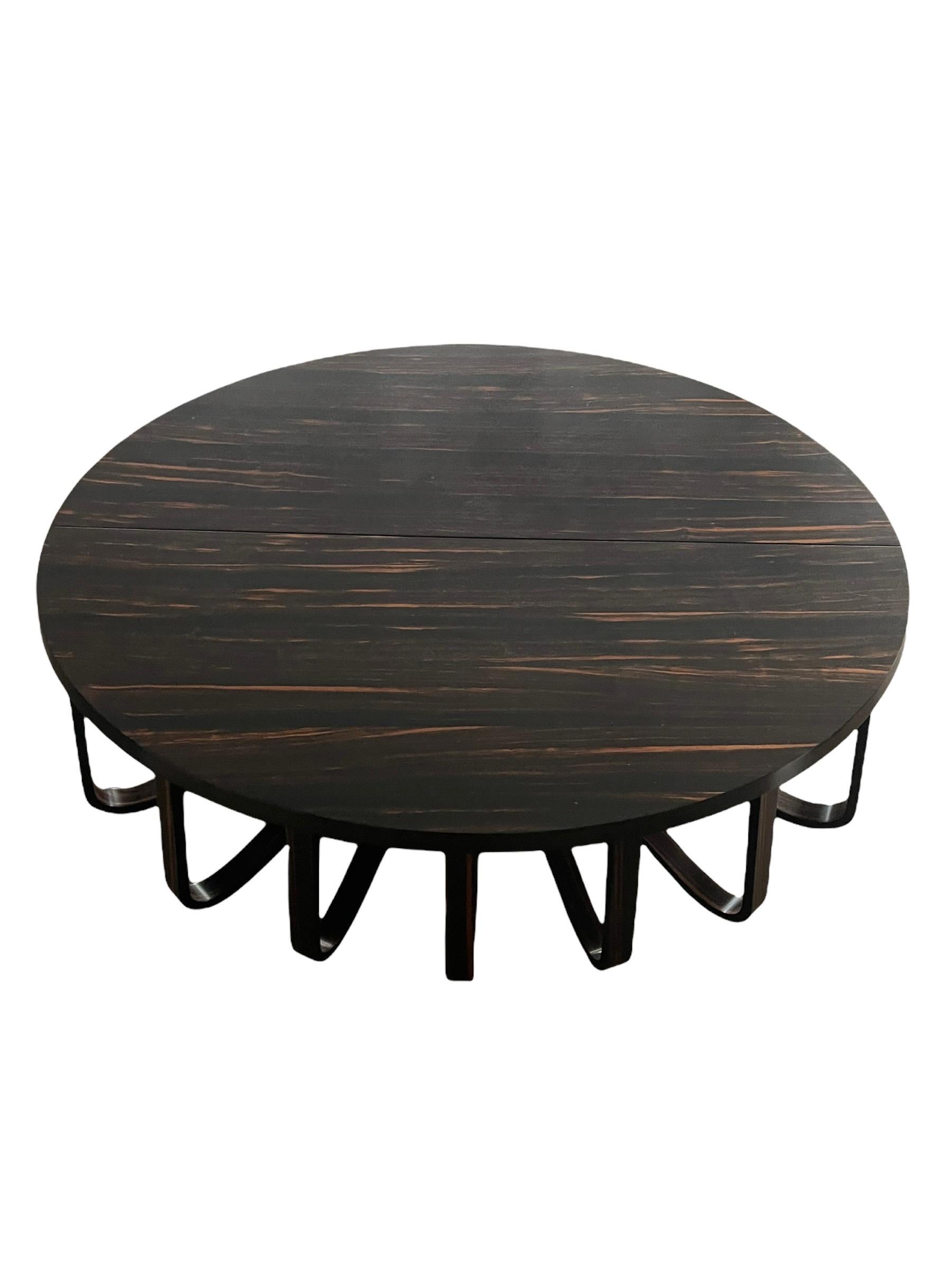 Very unique and rare contemporary pair of half oval shaped coffee tables that go together as one. Macassar top and walnut base, designed by Ralph Rucci for Holly hunt. It was a special edition in which only a few were made. 

Measures: Together: