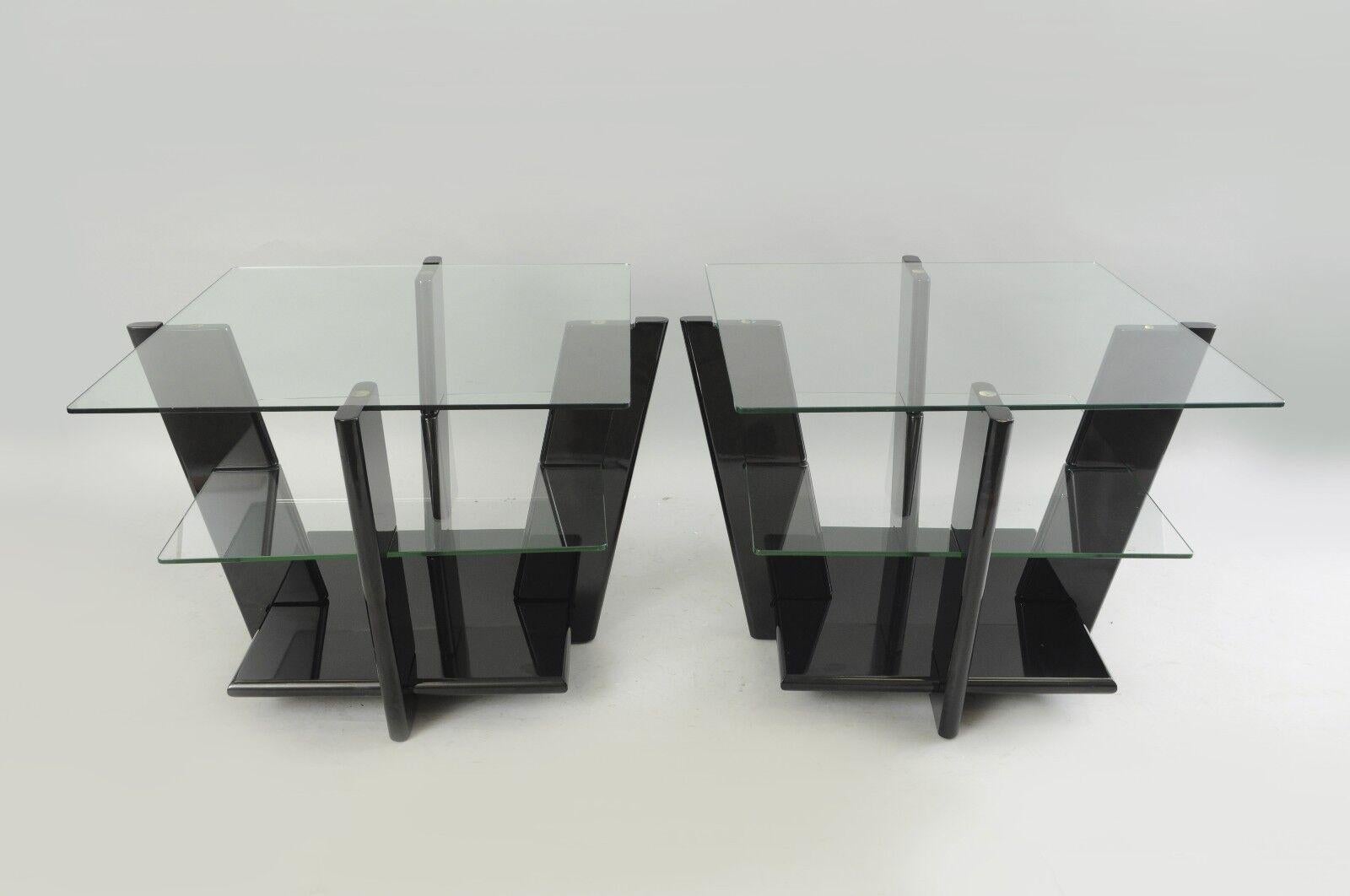 Large pair of contemporary modern black lacquer & glass sculptural 3 tier end tables. Item features unique black lacquered bases, 2 square glass tiers, one solid lower surface, 4 angled supports, sleek Modern form, very impressive tables. Circa Late