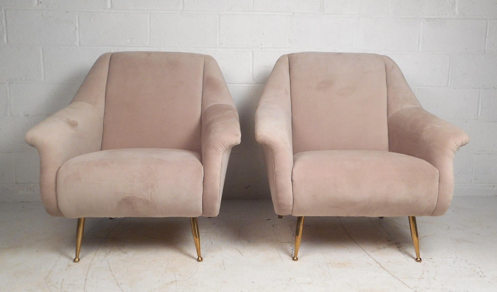 This gorgeous pair of Italian style lounge chairs are the height of comfort. These chairs feature wide and thick seat cushions for a delightful sitting experience. The chairs have winged armrests along with a high back. Wrapped in a plush upholstery