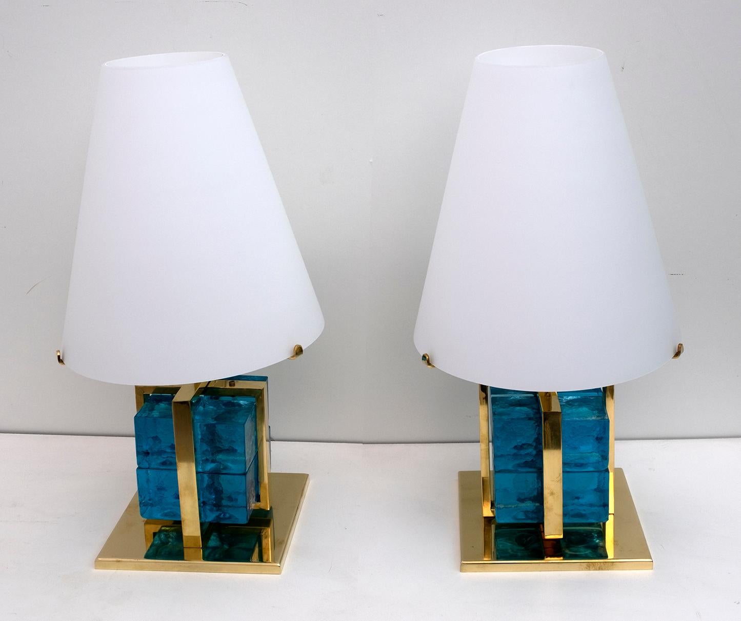 Pair of brass cage lamps with imposing and massive cubes in pressed blue Murano glass. The lampshade is in white 