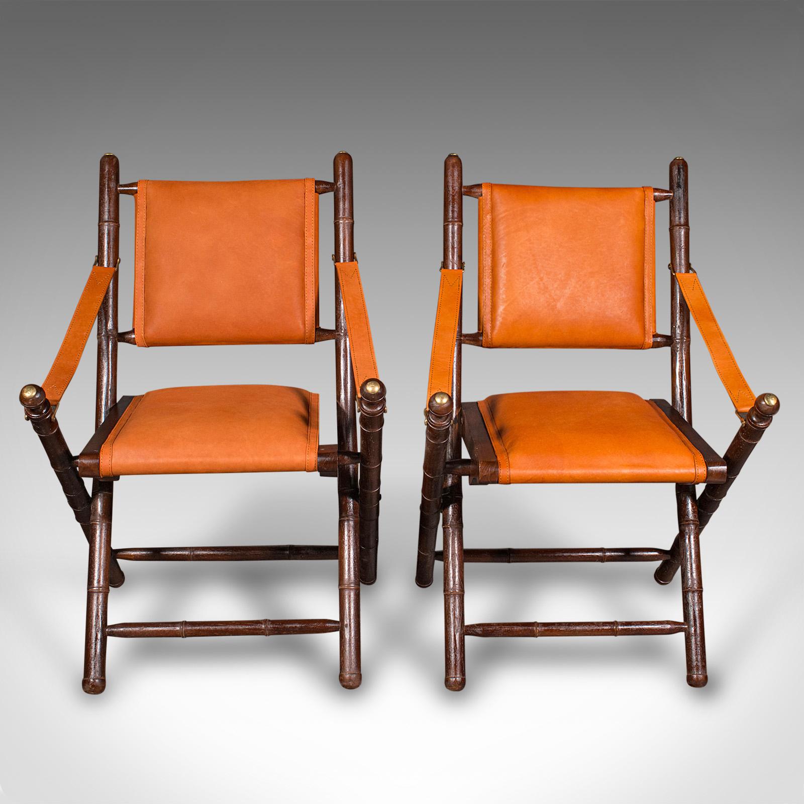 This is a pair of contemporary orangery chairs. An English, colonial style faux bamboo and leather folding veranda or patio seat.

Vibrant and well appointed outdoor or occasional chairs
Presented in very good order throughout
Crafted pine in the