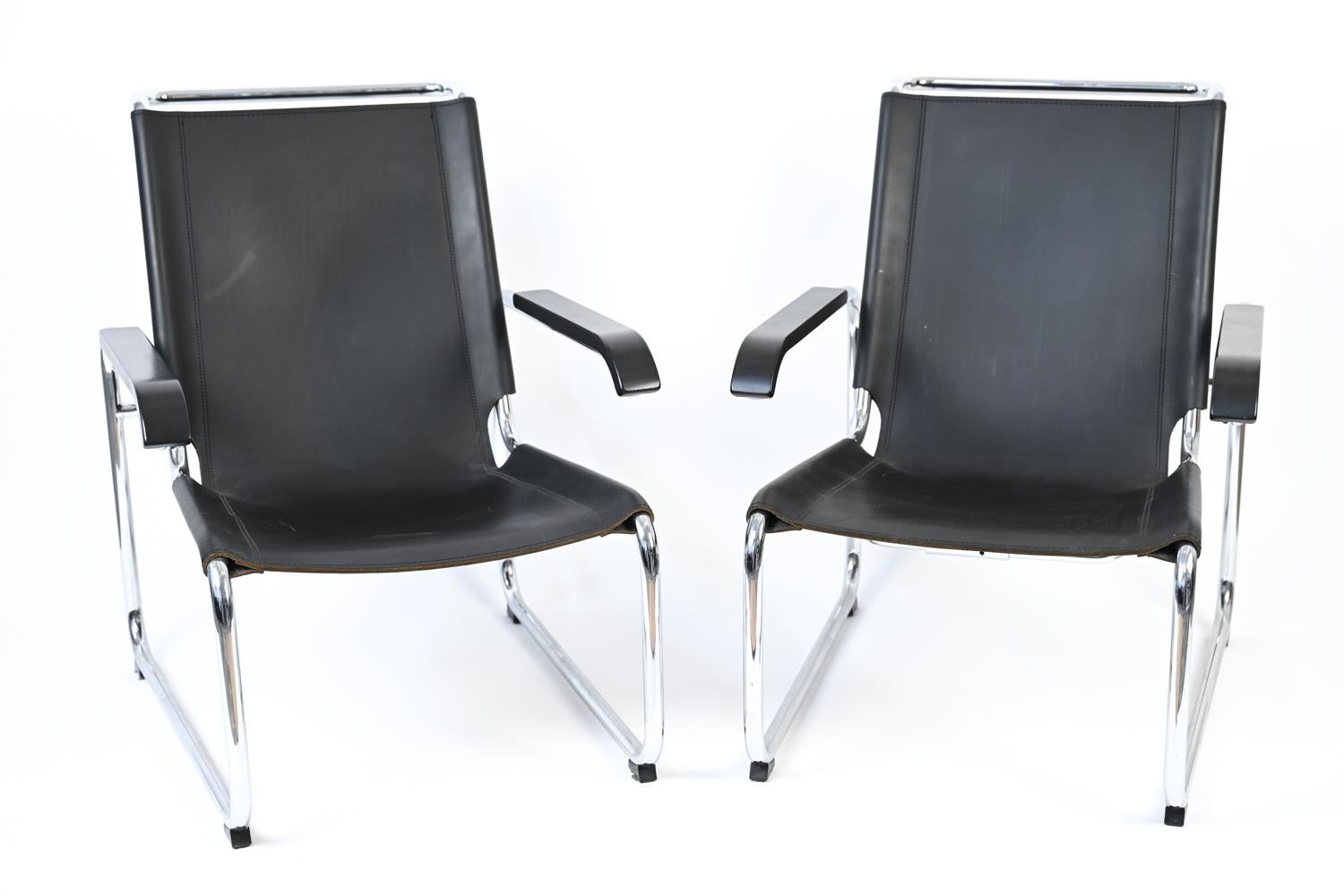 This pair of iconic S 35 lounge chairs features heavy-duty black leather seats slung over tubular polished chrome frames, with black stained beechwood armrests and foot glides for protection. 

In design, there is no greater endorsement than the