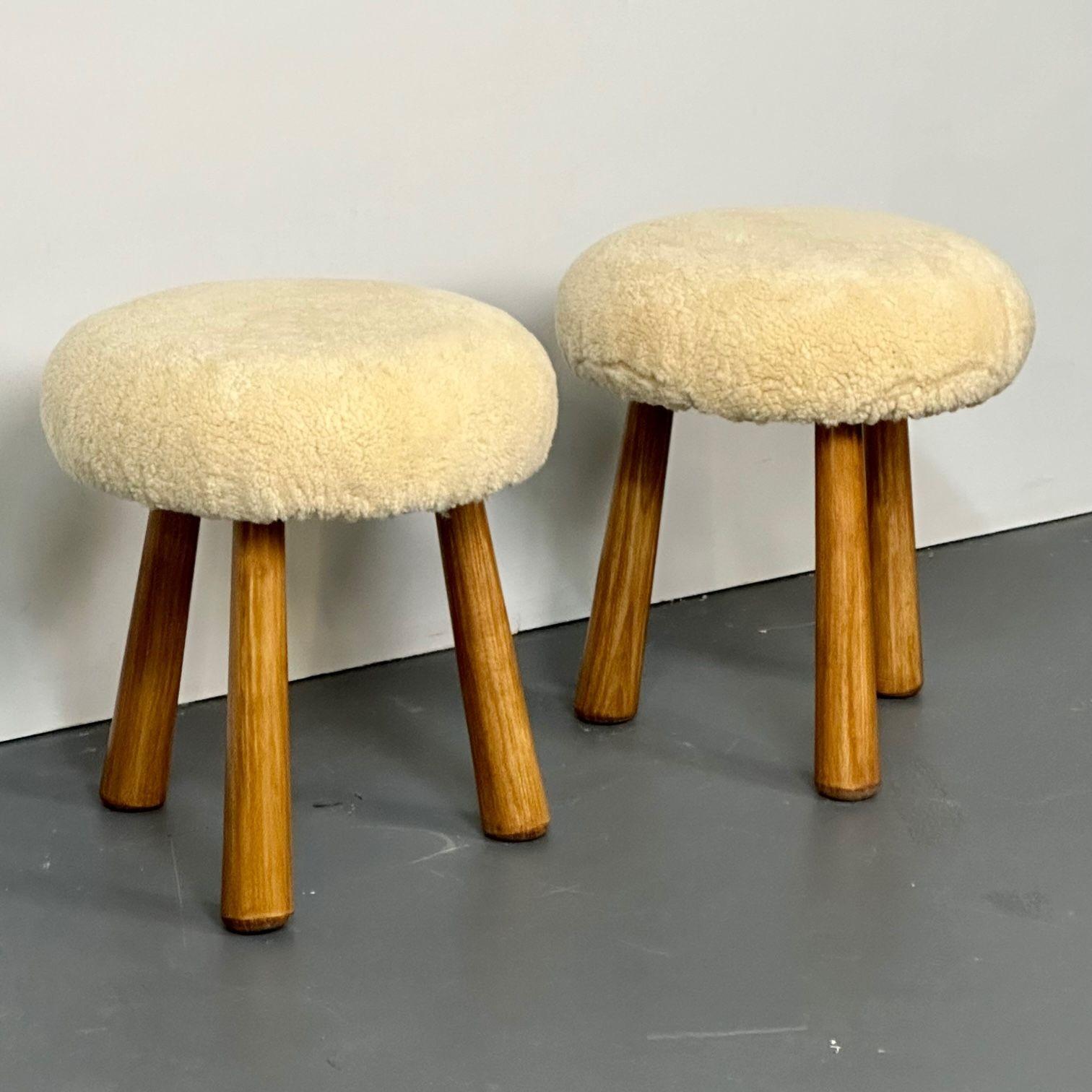 Pair of contemporary Scandinavian modern style beige sheepskin stools / ottomans
Contemporary organic form tri-pod stools or ottomans. New memory foam cushioning and genuine shearling. Can mix and match beige or honey sheepskin color stools. The