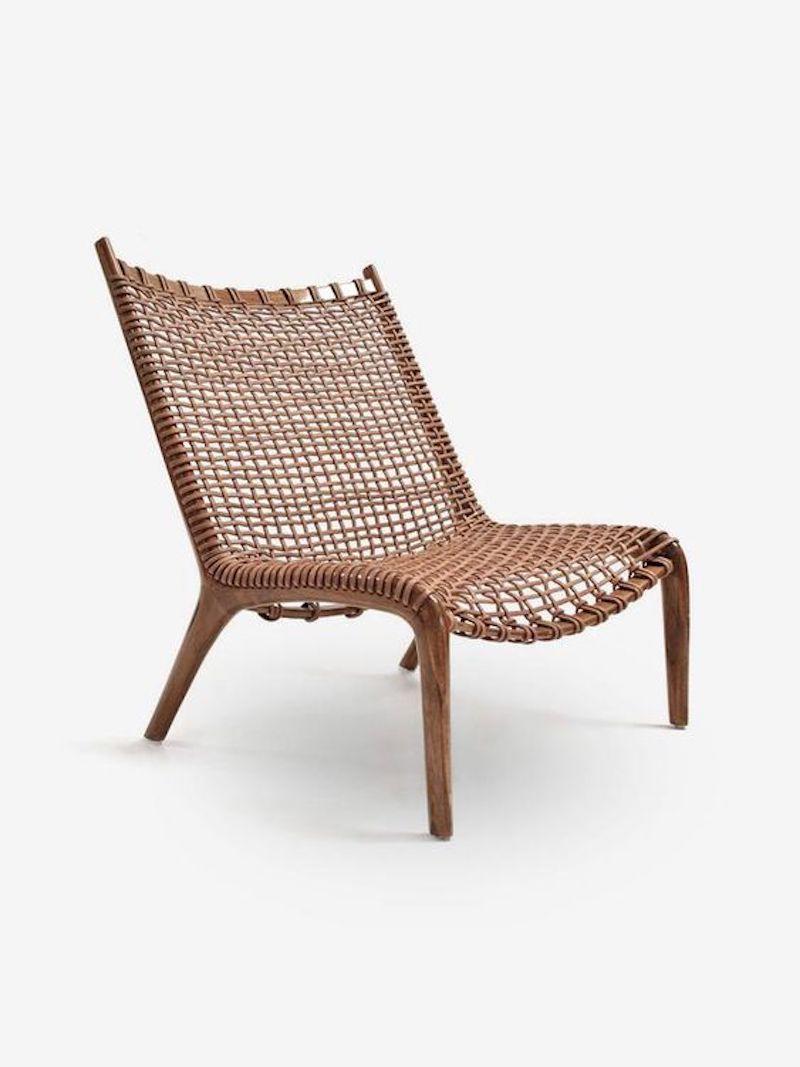 Pair of contemporary vintage influenced chairs by Scala Luxury. They are made from solid teak wood with leather-woven strap seats and backs. The frame is finished in a warm color and a gloss lacquer topcoat. 

(Image 5: Contemporary Teak and