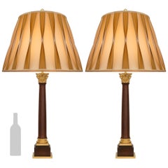 pair of Continental 19th century Neo-Classical st. Mahogany and Ormolu lamps