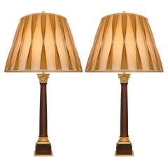 pair of Continental 19th century Neo-Classical st. Mahogany and Ormolu lamps