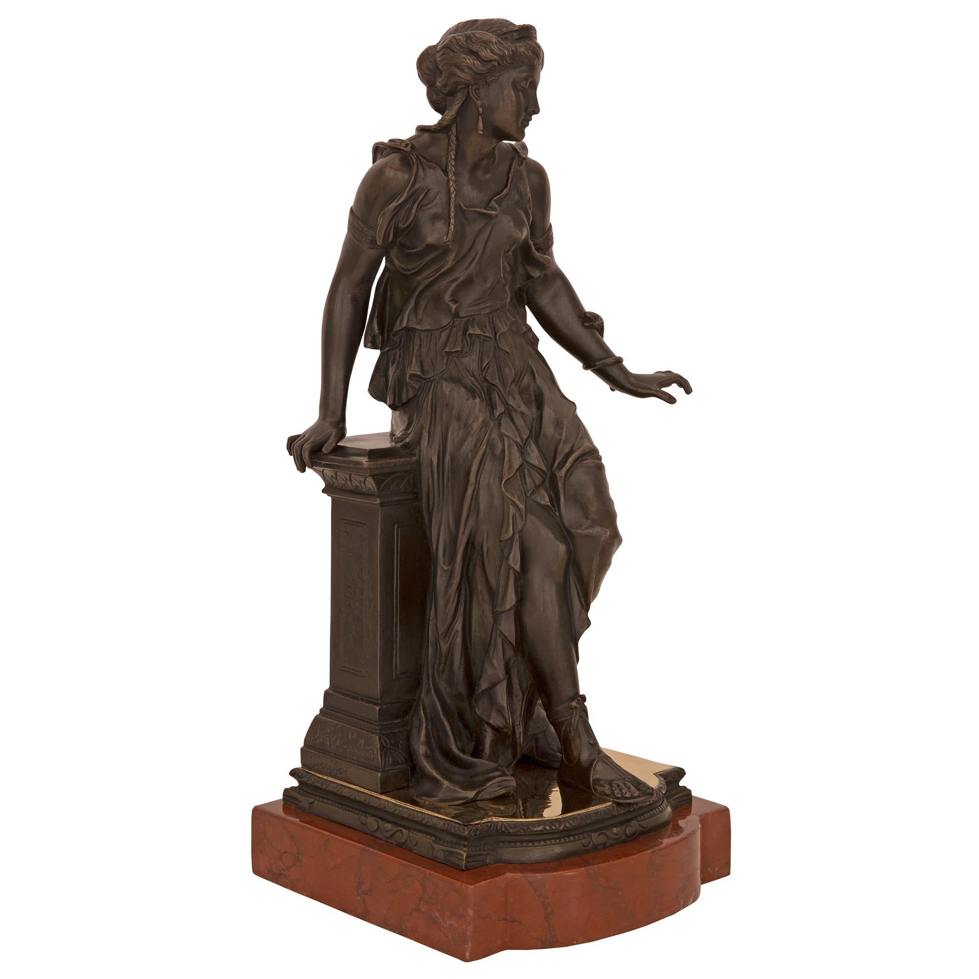 A striking and high quality pair of Continental 19th century neo-classical st. patinated bronze and Rouge Griotte marble statues, signed J. Feiffer. Each statue is raised by a fine thick Rouge Griotte marble base with a rounded front. The impressive