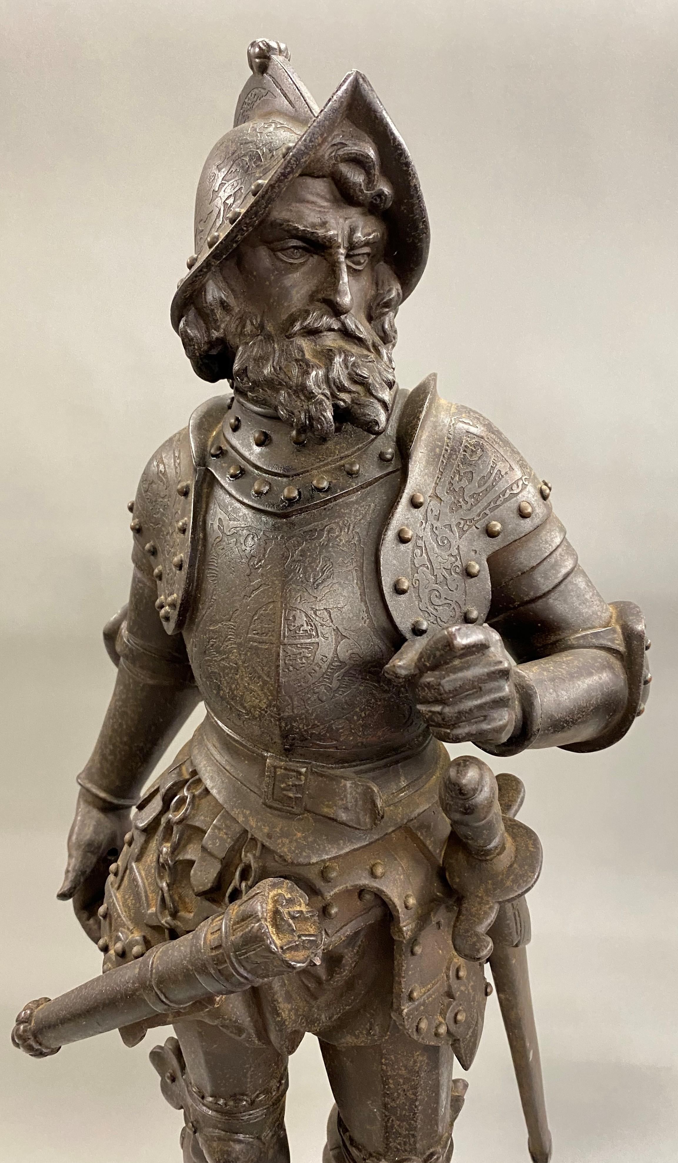 A finely detailed pair of Medieval patinated cast iron soldier statues mounted on round Majolica and cast iron reticulated bases, the left reading “Anglais 1429,” and the right reading “Francais 1429” around the base. The swords and gun are slightly