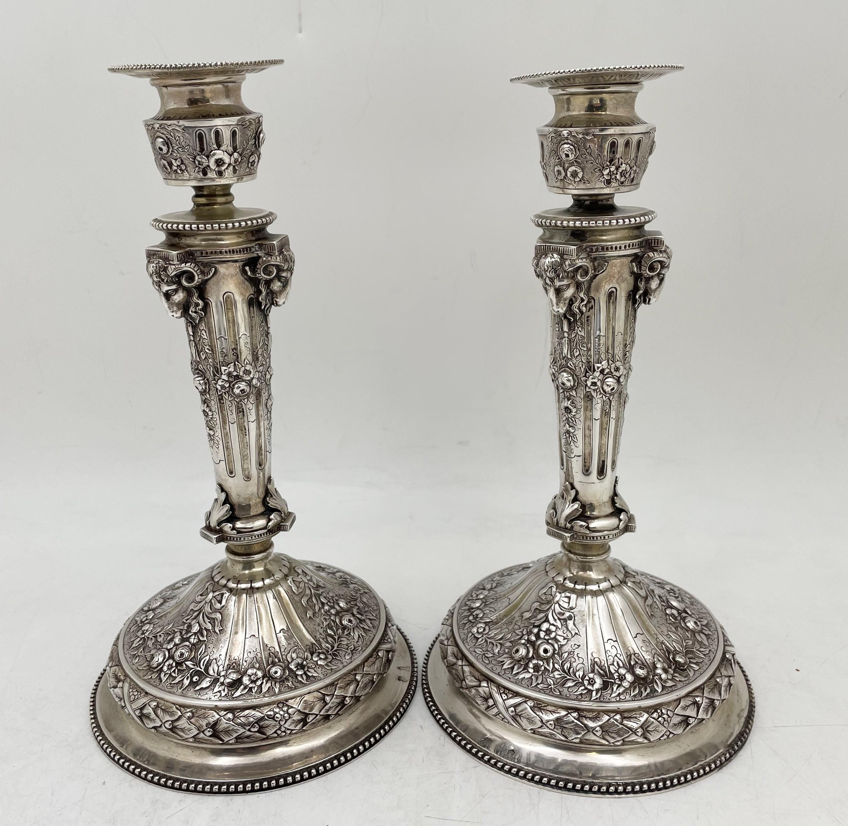 Continental Chased silver Candlesticks from 19th century in a floral pattern. These unique works feature ram's heads and a rose pattern that was hand chased in beautiful detail. These pieces are 10