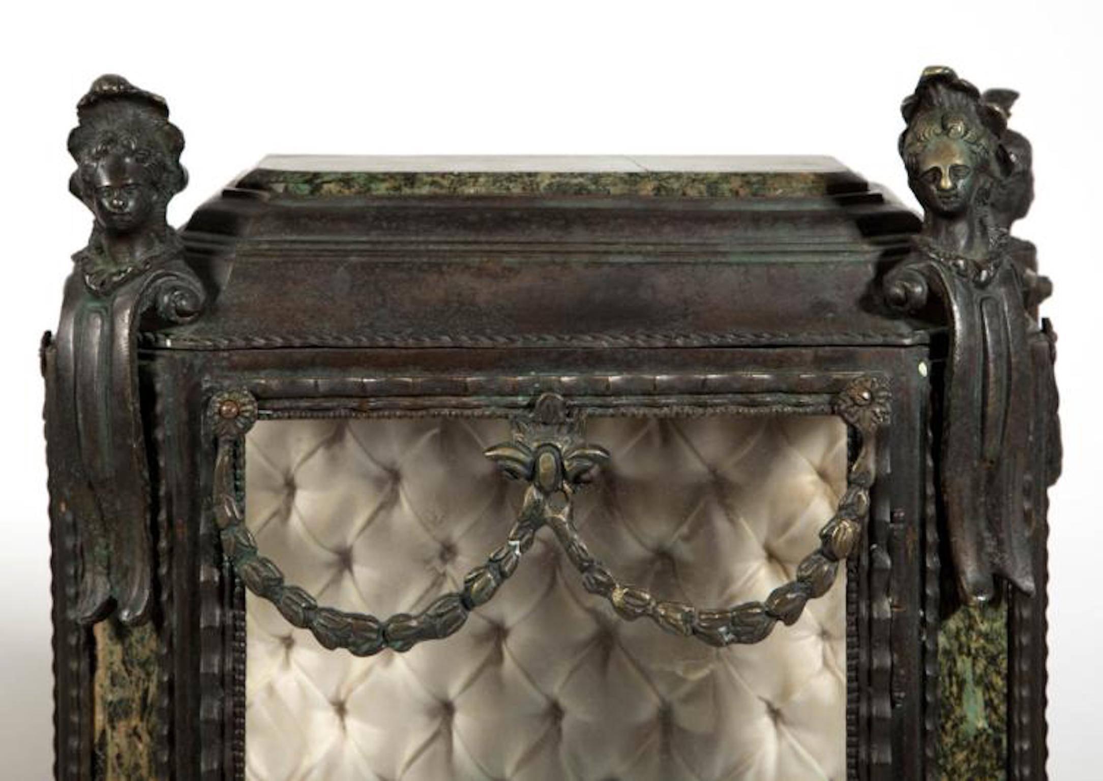 Pair of Continental Louis XIV-style cast-zinc curio cabinets, diminutive size, ornamentation including swags, busts, green marble accents, and urn-form base, silk-tufted interior, bronze patina.