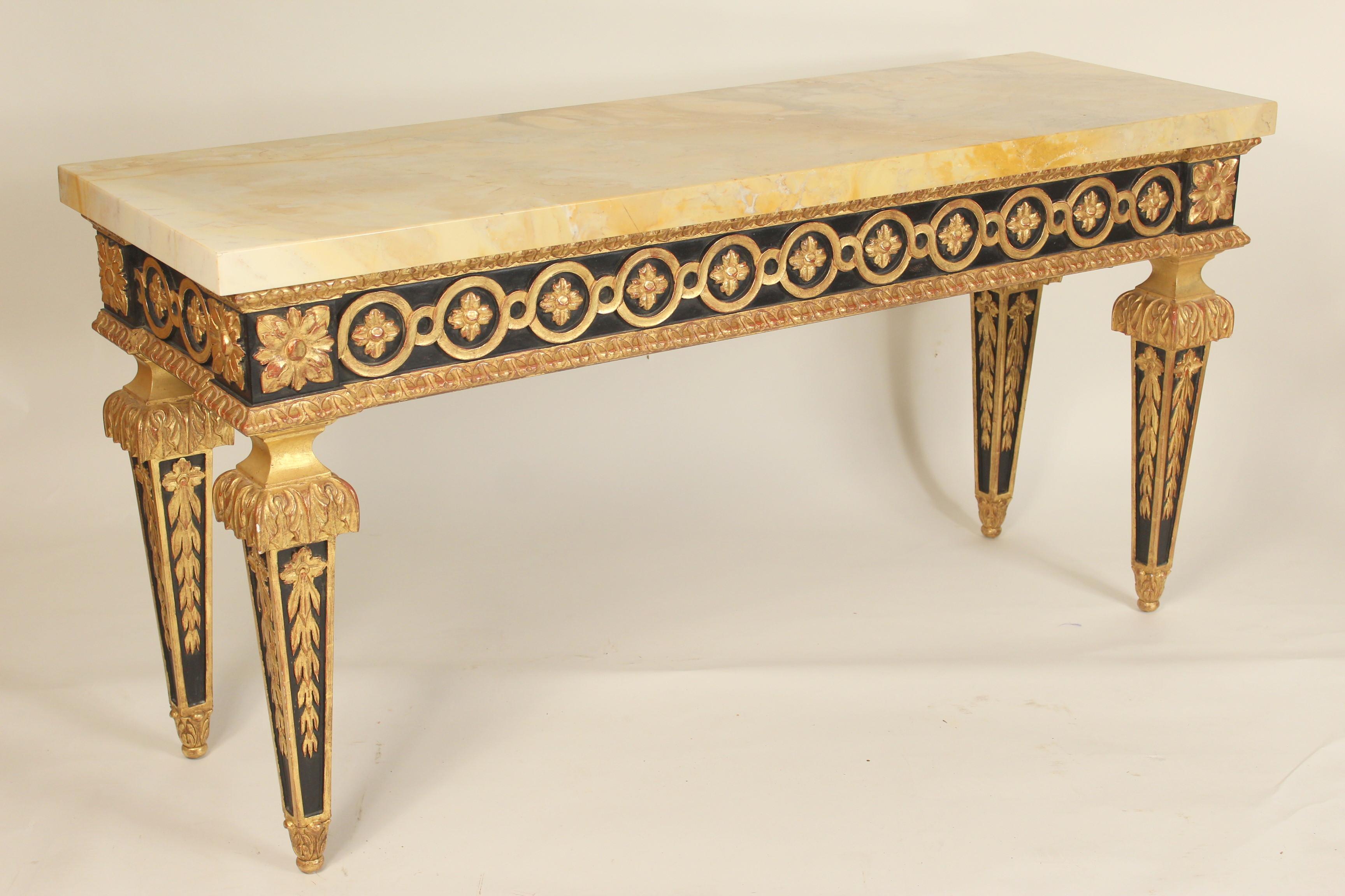 Pair of Louis XVI style painted and gilt decorated console tables with veneered marble tops, circa 2000. The gilding on these consoles is Dutch foil. The sides of the tops has .75