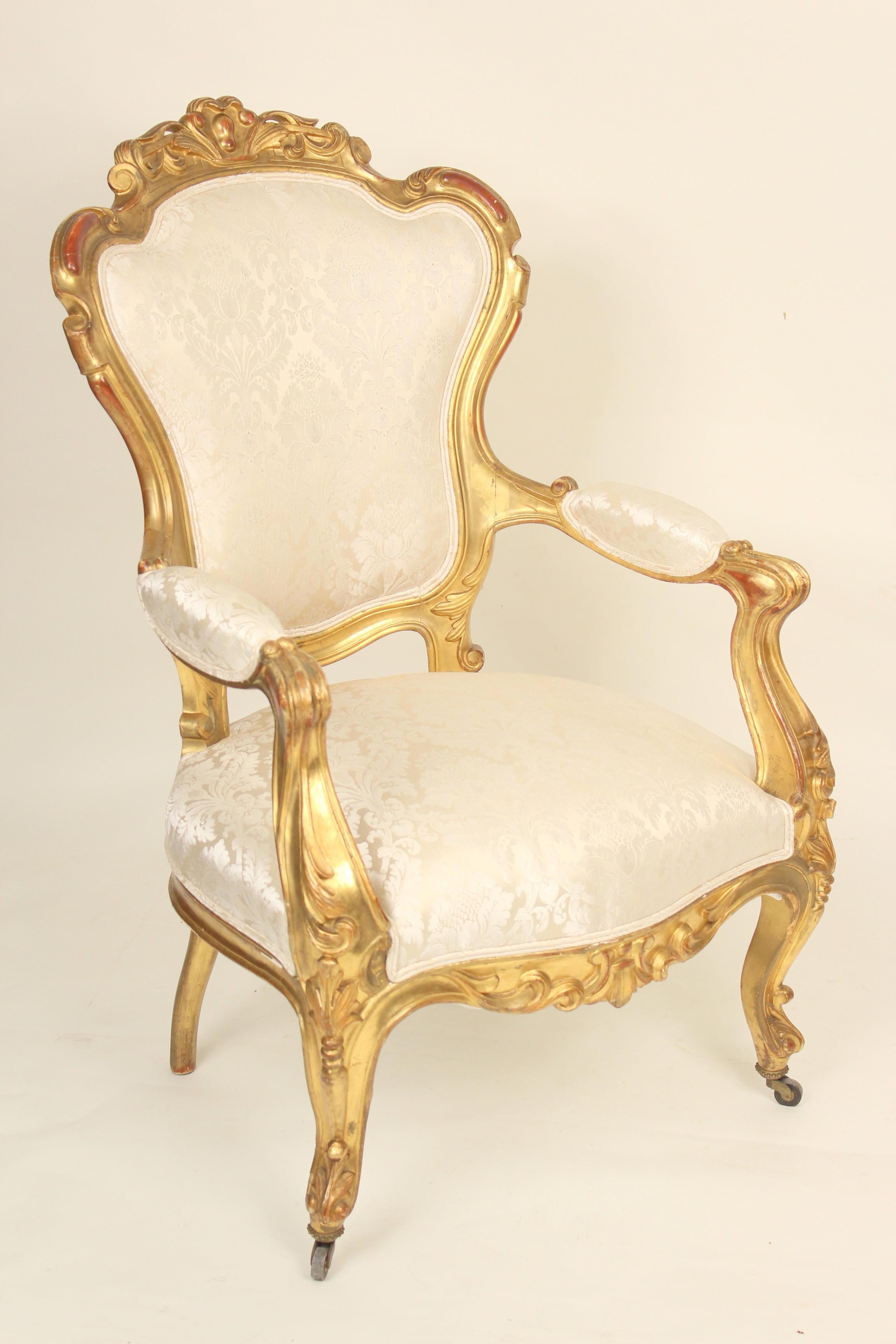 Pair of continental (possibly Venetian) Napoleon III gilt wood armchairs, 19th century. These chairs have old original gold leaf finish with some paint touch, mostly on the backs. The frames are tight and the upholstery is new and in excellent